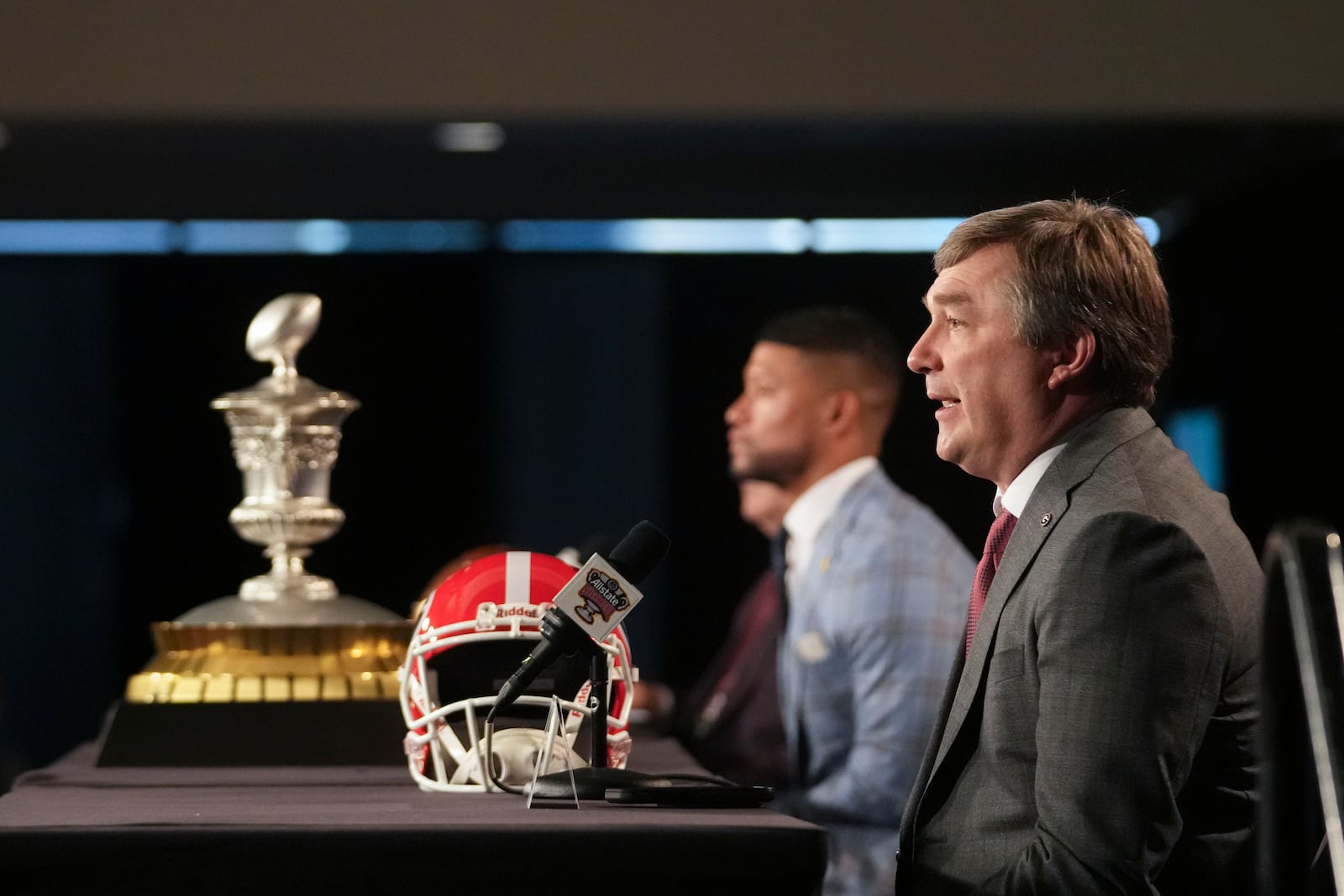 Georgia head coach Kirby Smart speaks to reporters with Notre Dame head coach Marcus Freeman, background, in New Orleans, Tuesday, Dec. 31, 2024. Georgia will face Notre Dame in the Sugar Bowl NCAA college football CFP quarterfinal game on Jan. 1, 2025. (AP Photo/Gerald Herbert)