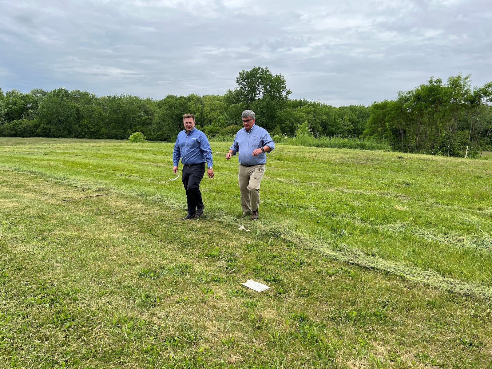 Jamie McGregor, L, stands in an open field behind the Leffel Lane facility that is part of McGregor Metal. The field will be the location of a 21,000 square-foot addition to the Leffel facility. Hasan Karim/Staff