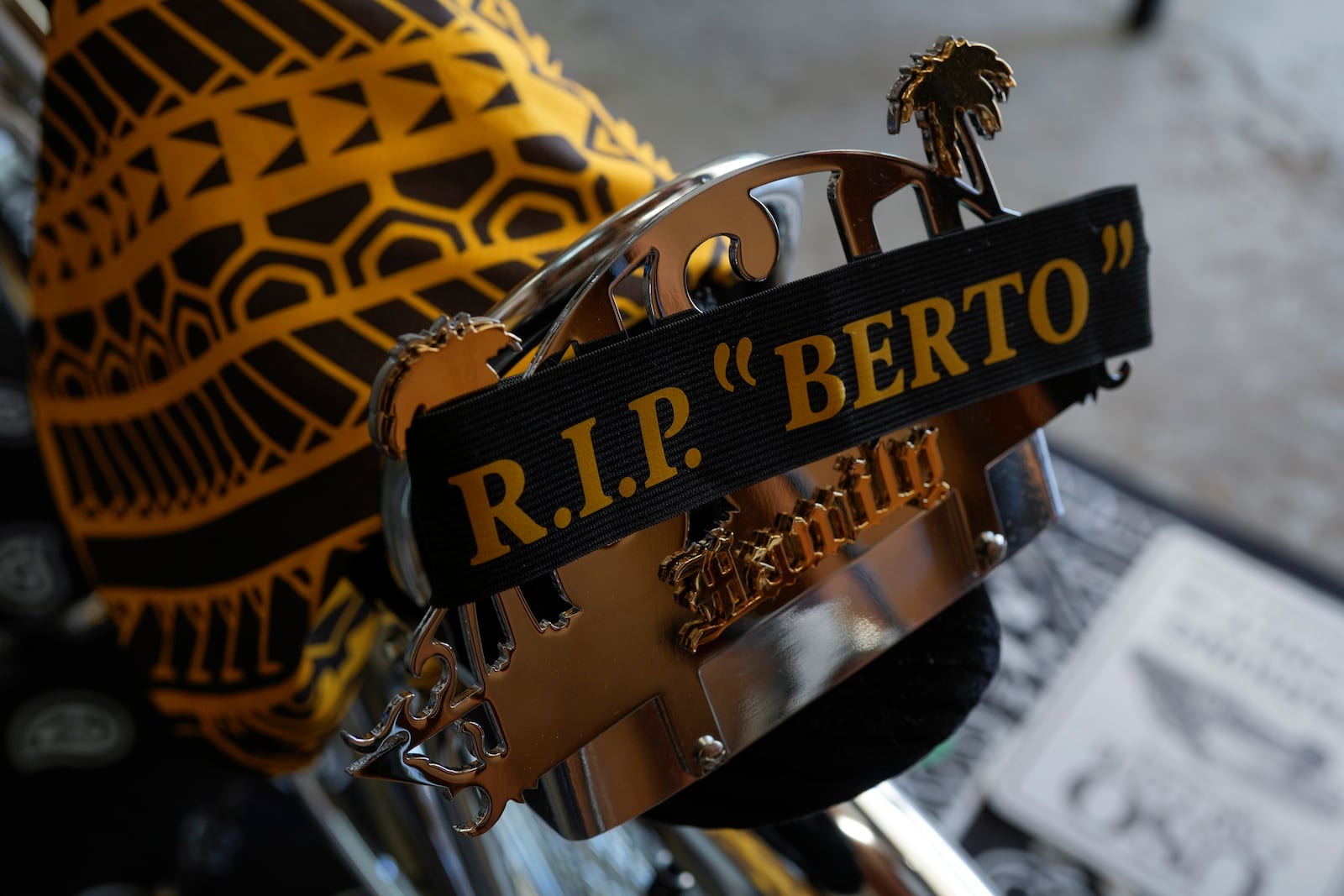 A sash paying tribute to the late Alberto Marquez adorns a Uso Car Club plaque attached to a custom chrome lowrider bike built by his 7-year-old son Daniel and family friends Saturday, Sept. 14, 2024, at his home in Frankfort, Ill. (AP Photo/Erin Hooley)