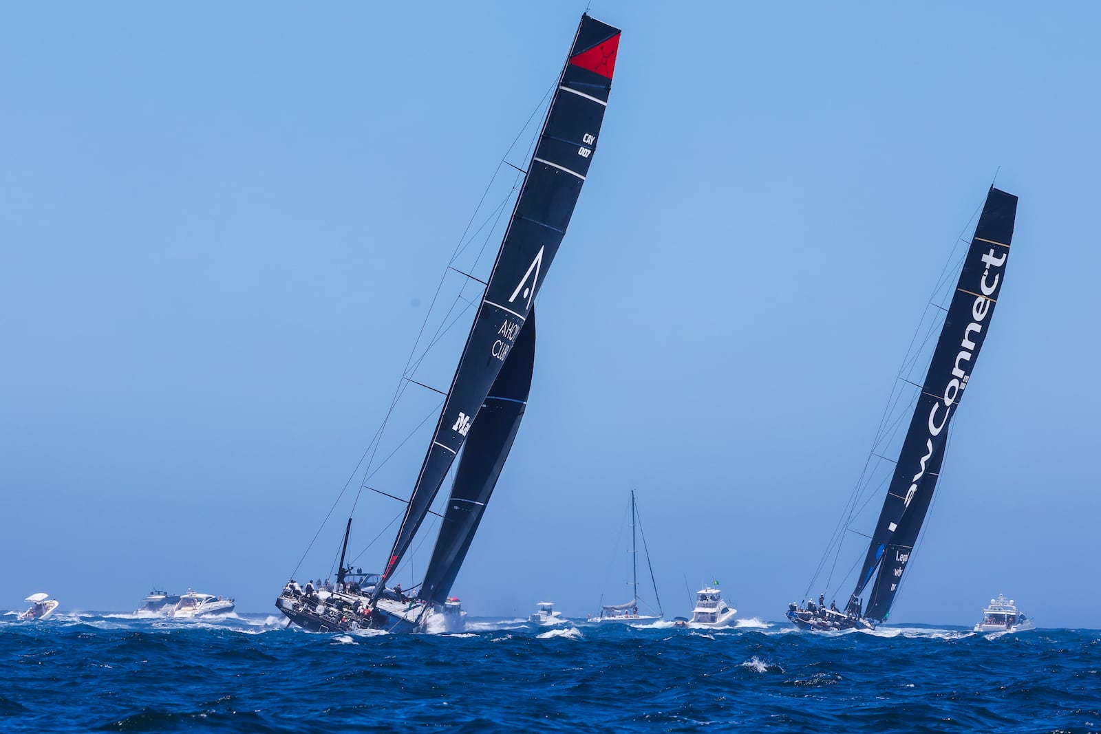 Master Lock Comanche, left, and LawConnect sail out of the heads following the start of the Sydney to Hobart yacht race in Sydney, Thursday, Dec. 26, 2024. (Mark Evans/AAP Image via AP).