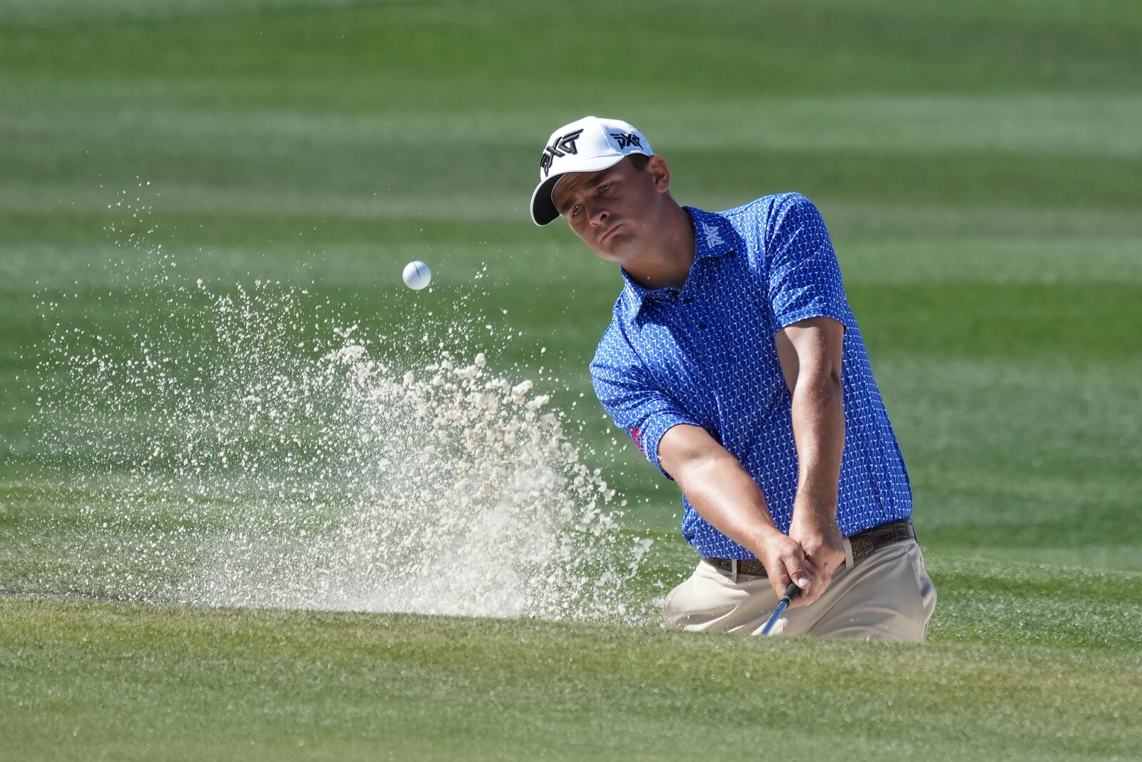 Christiaan Bezuidenhout, of South Africa, hits out of a bunker at the ninth green during the first round of the Waste Management Phoenix Open PGA Tour golf tournament at the TPC Scottsdale Thursday, Feb. 6, 2025, in Scottsdale, Ariz. (AP Photo/Ross D. Franklin)