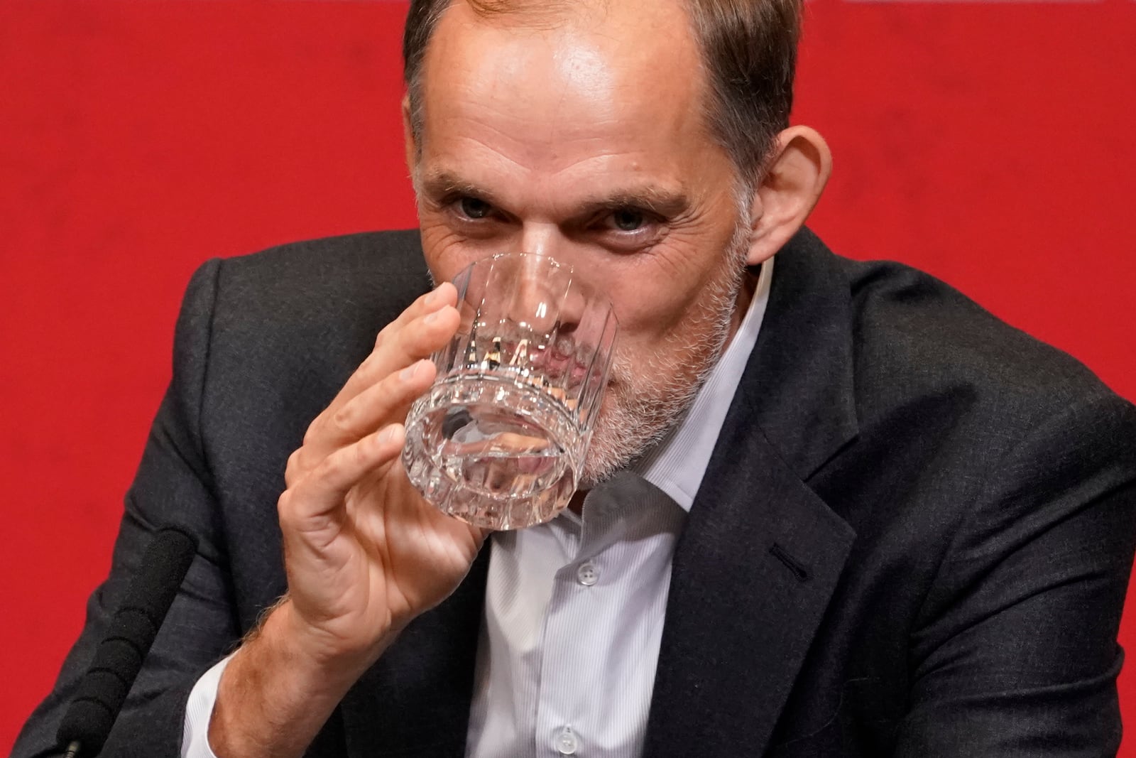 The newly appointed England men's soccer team manager Thomas Tuchel takes a drink as he listens to a question during a press conference held at Wembley Stadium in London, Wednesday, Oct. 16, 2024. (AP Photo/Alberto Pezzali)