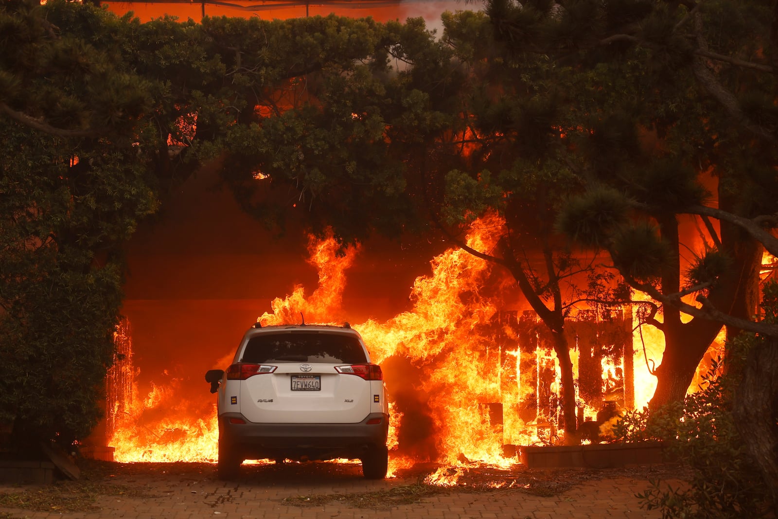 The Palisades Fire burns a structure in the Pacific Palisades neighborhood of Los Angeles, Wednesday, Jan. 8, 2025. (AP Photo/Etienne Laurent)