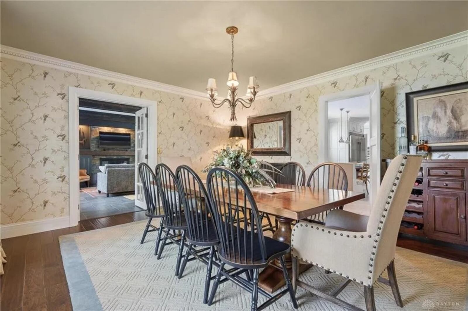 The formal dining room has wainscoting and access to the kitchen and the family room.