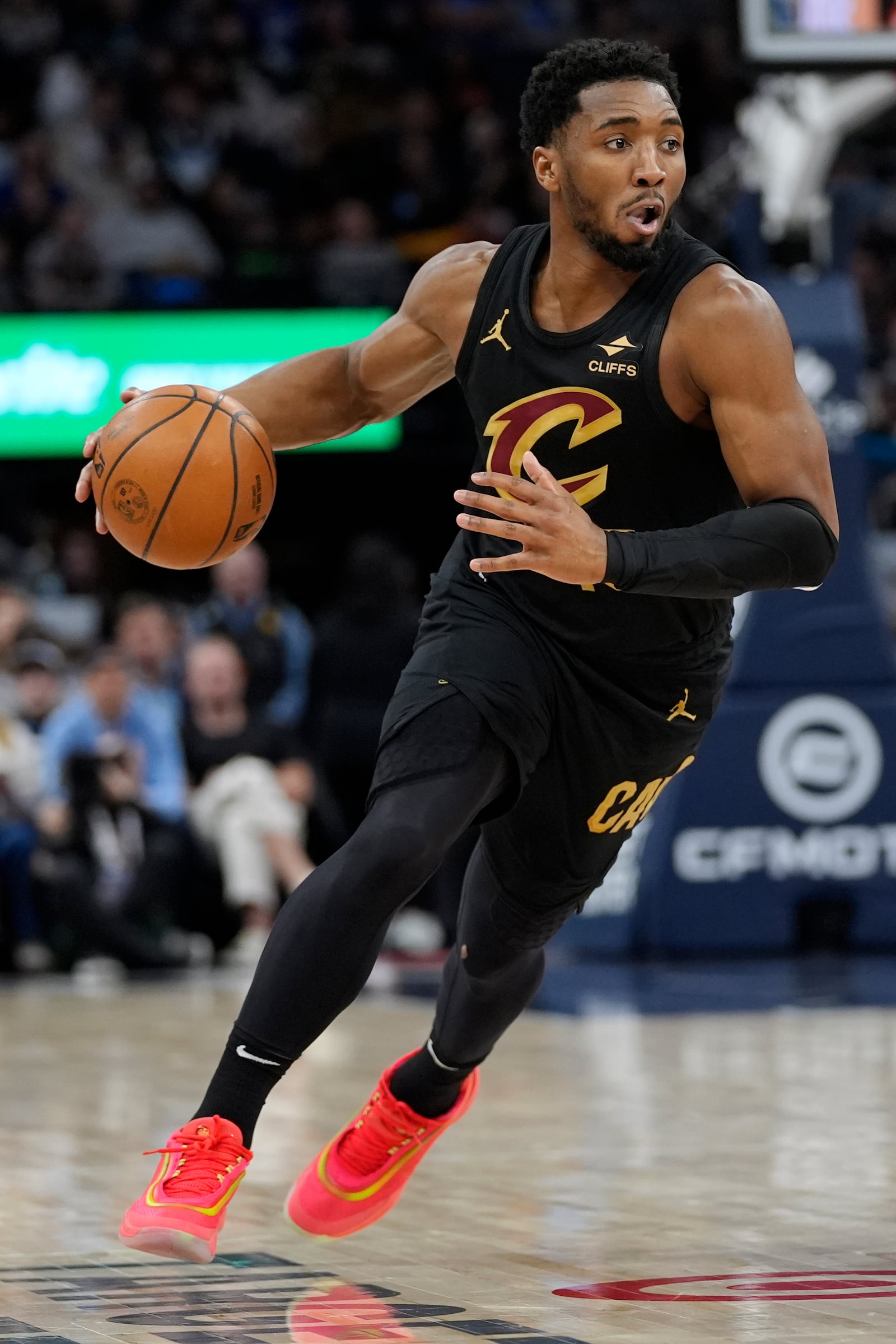 Cleveland Cavaliers guard Donovan Mitchell dribbles downcourt during the first half of an NBA basketball game against the Minnesota Timberwolves, Saturday, Jan. 18, 2025, in Minneapolis. (AP Photo/Abbie Parr)