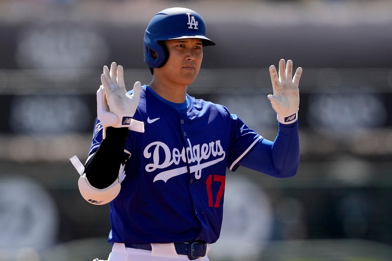 Los Angeles Dodgers' Shohei Ohtani calls time after hitting a double against the Arizona Diamondbacks during the first inning of a spring training baseball game, Monday, March 10, 2025, in Phoenix. (AP Photo/Matt York)