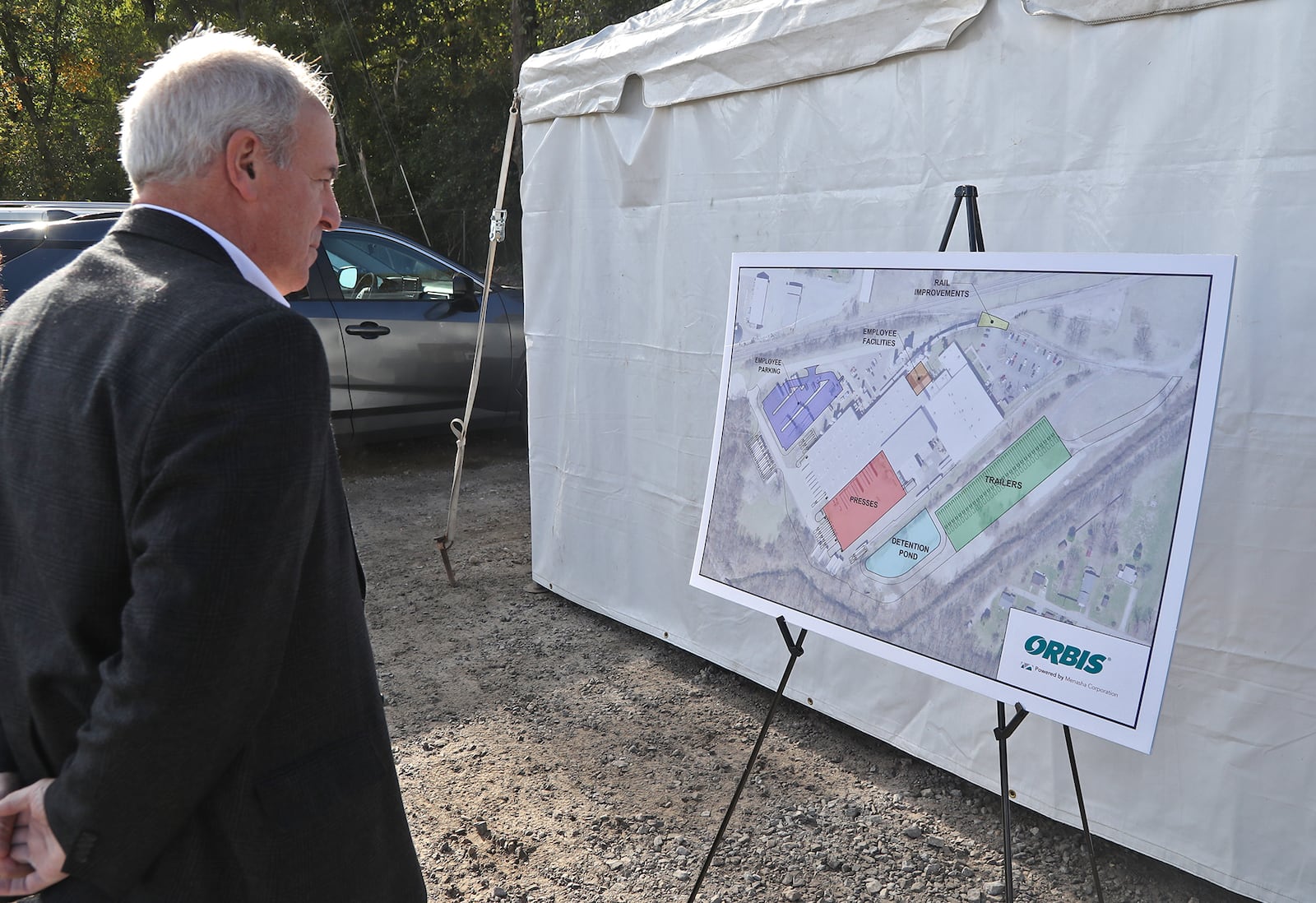 Kerry Brugger, the Urbana City Administrator, looks over the plans for the expansion of the ORBIS Corporation Tuesday, Oct. 4, 2022 before the goundbreaking ceremony Urbana. BILL LACKEY/STAFF