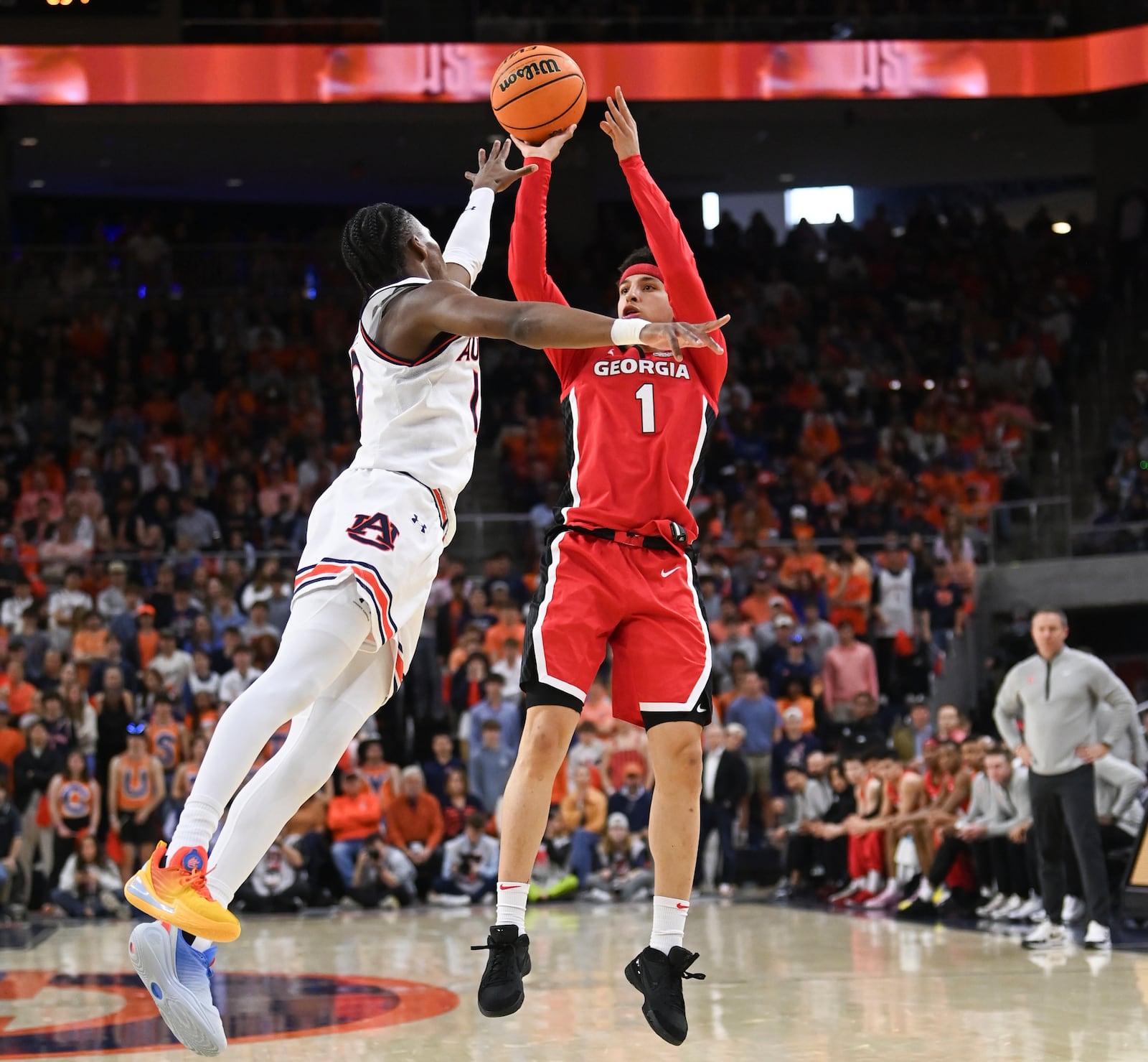 Auburn guard Miles Kelly (13) defends a shot by Georgia guard Dakota Leffew (1) during the first half an NCAA college basketball game Saturday, Feb. 22, 2025, in Auburn, Ala. (AP Photo/Julie Bennett)