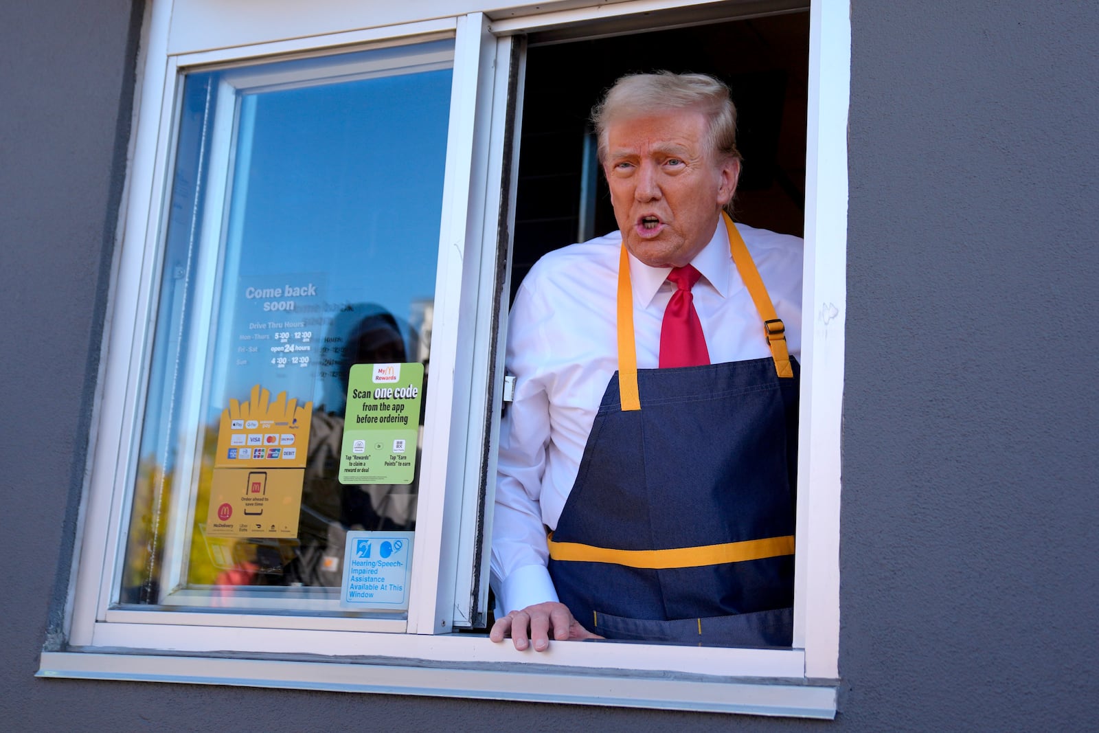 Republican presidential nominee former President Donald Trump speaks from a drive-thru window during a campaign stop at a McDonald's, Sunday, Oct. 20, 2024, in Feasterville-Trevose, Pa. (AP Photo/Evan Vucci)