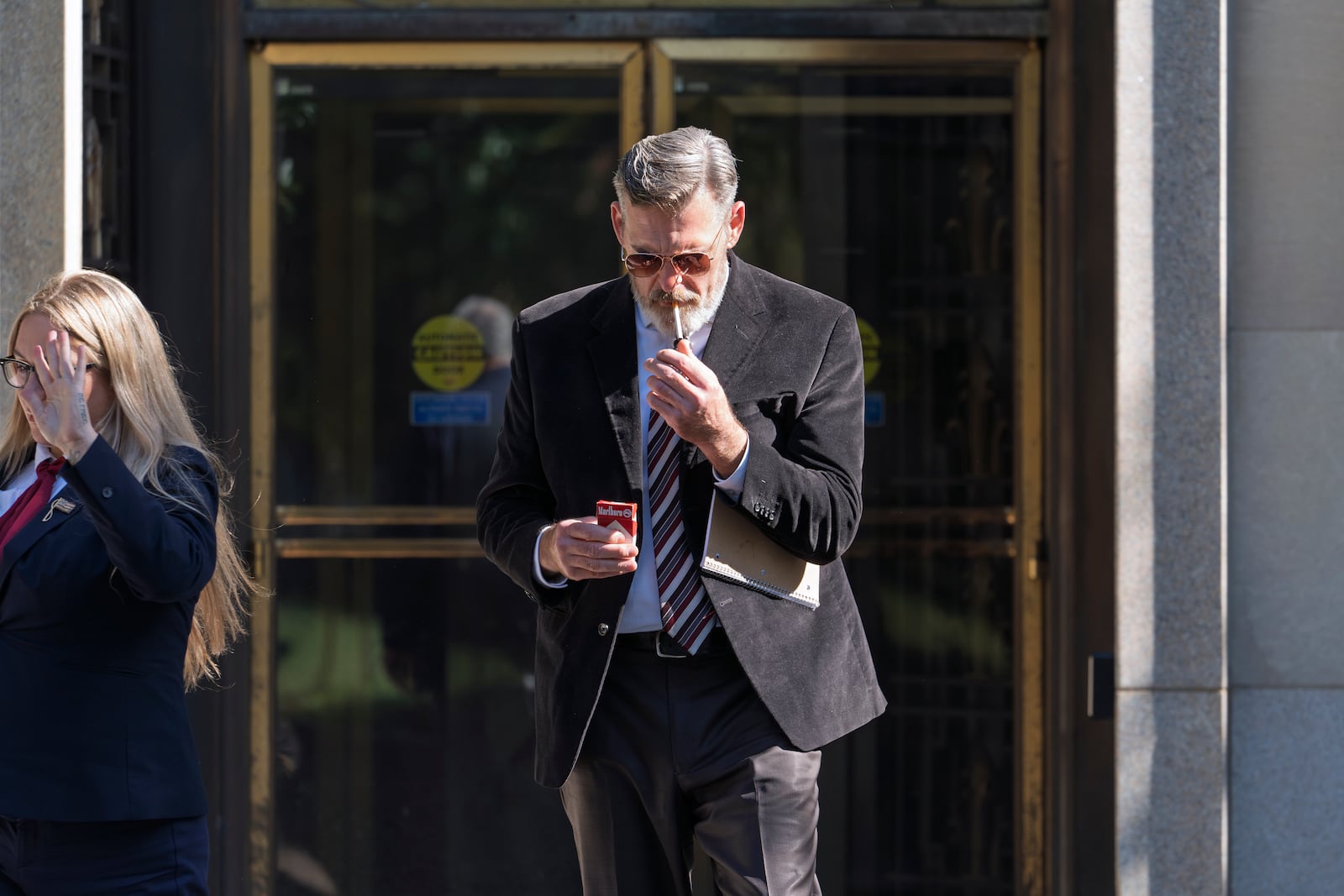 Actor Jay Johnston emerges from the U.S. District Courthouse in Washington, Monday, Oct. 28, 2024, after been sentenced to one year in prison for his part in a mob’s attack on the U.S. Capitol nearly four years ago. Johnston joined other rioters in a “heave ho” push against police officers guarding a tunnel entrance to the Capitol during the Jan. 6, 2021, riot. (AP Photo/J. Scott Applewhite)