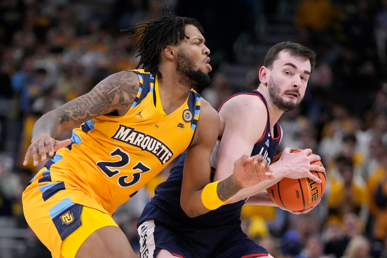 UConn's Alex Karaban tries to get past Marquette's David Joplin during the second half of an NCAA college basketball game Saturday, Feb. 1, 2025, in Milwaukee. (AP Photo/Morry Gash)