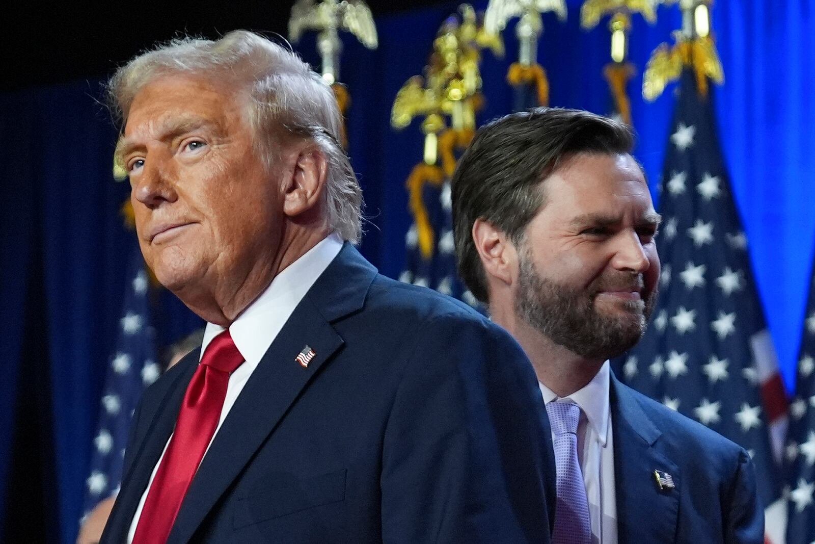 Republican presidential nominee former President Donald Trump, left, with Republican vice presidential nominee Sen. JD Vance, R-Ohio, right, at an election night watch party at the Palm Beach Convention Center, Wednesday, Nov. 6, 2024, in West Palm Beach, Fla. (AP Photo/Evan Vucci)