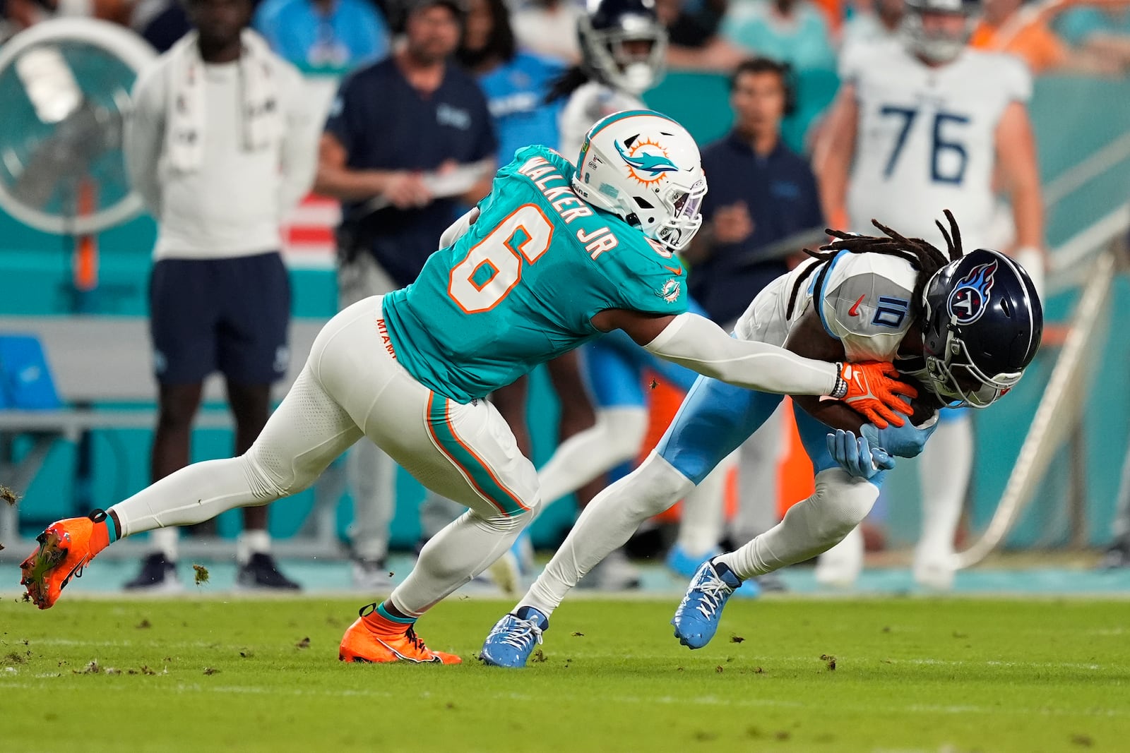 Miami Dolphins linebacker Anthony Walker Jr. (6) defends Tennessee Titans wide receiver DeAndre Hopkins (10) during the first half of an NFL football game, Monday, Sept. 30, 2024, in Miami Gardens, Fla. (AP Photo/Rebecca Blackwell)