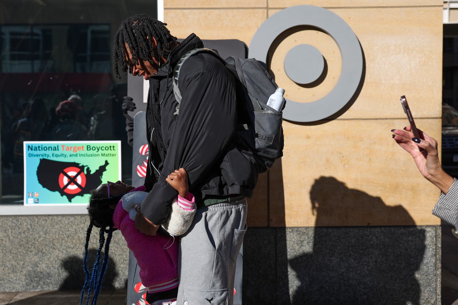 Assata Armstrong, left, 7, greets her brother PJ Pounds before a news conference outside Target Corporation's headquarters Thursday, Jan. 30, 2025, in Minneapolis, Minn. (AP Photo/Ellen Schmidt)