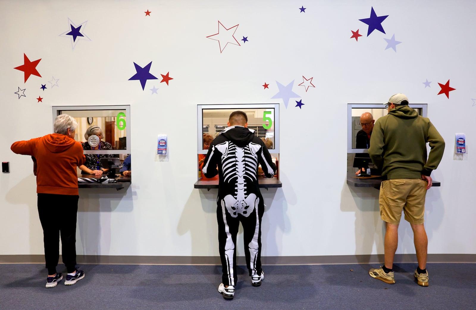 Ready for Halloween, Mark Reynolds shows his identification to vote at the St. Charles County Election Authority as early voting continues in St. Charles, Mo. on Thursday, Oct. 31, 2024. (Robert Cohen/St. Louis Post-Dispatch via AP)