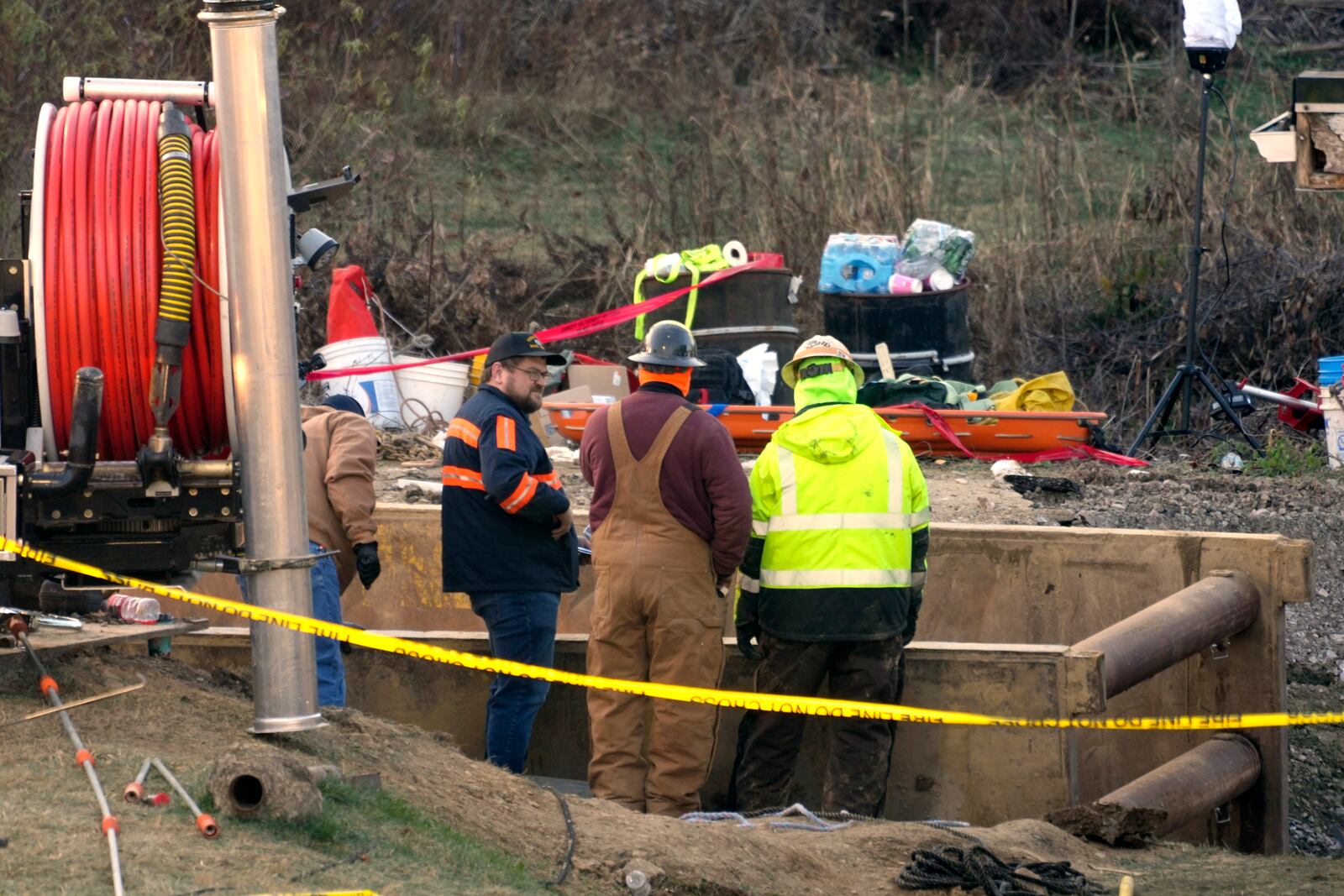 Rescue workers continue to search, Wednesday, Dec. 4, 2024, for Elizabeth Pollard, who is believed to have disappeared in a sinkhole while looking for her cat, in Marguerite, Pa. (AP Photo/Gene J. Puskar)