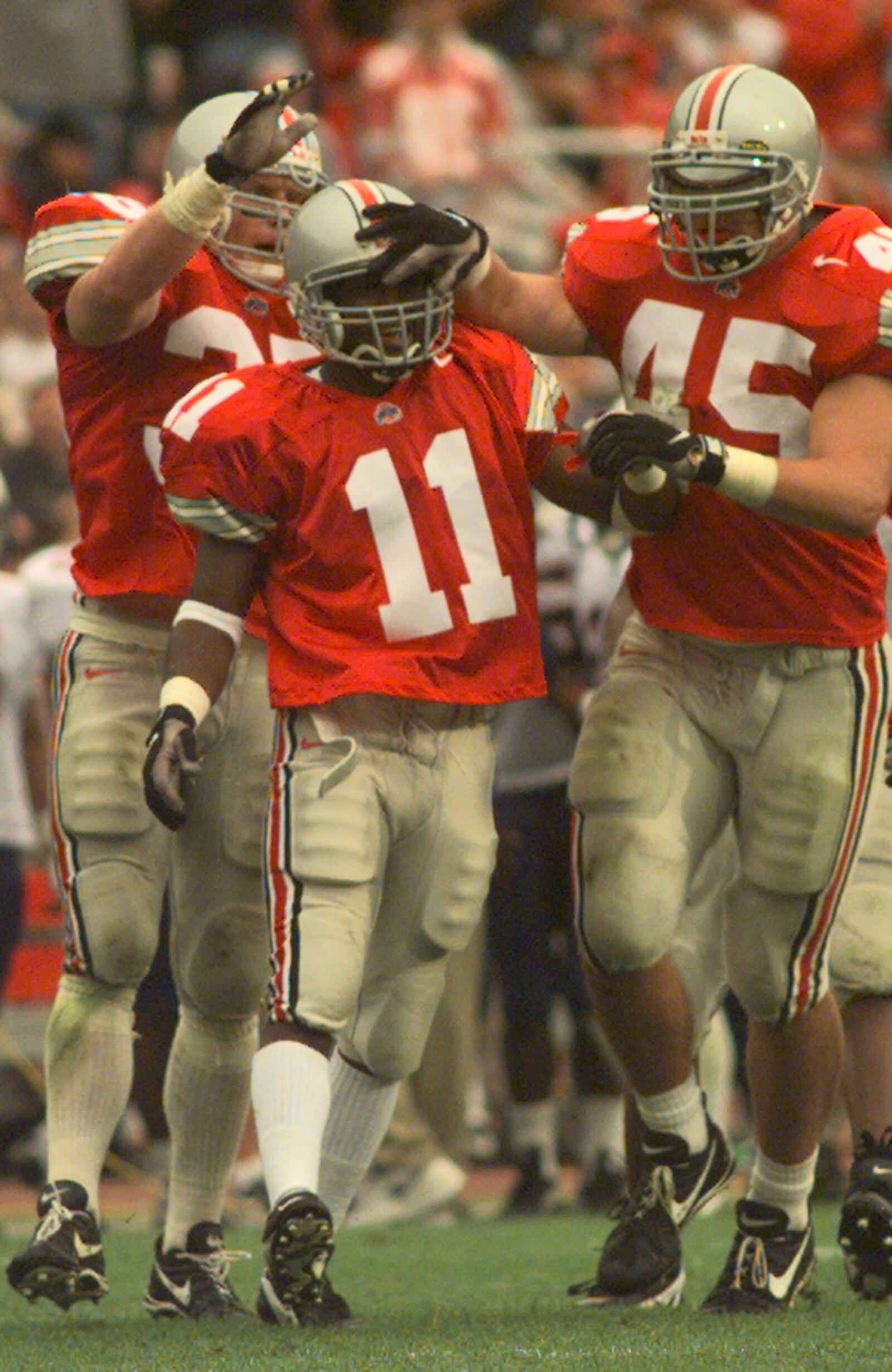 ##RAW FILE## OSU’s Antoine Winfield (#11) celebrates a tackle with teammates Jerry Rudzinski(behind) and Andy Katzenmoyer(#45) against Arizona, September 20, 1997.