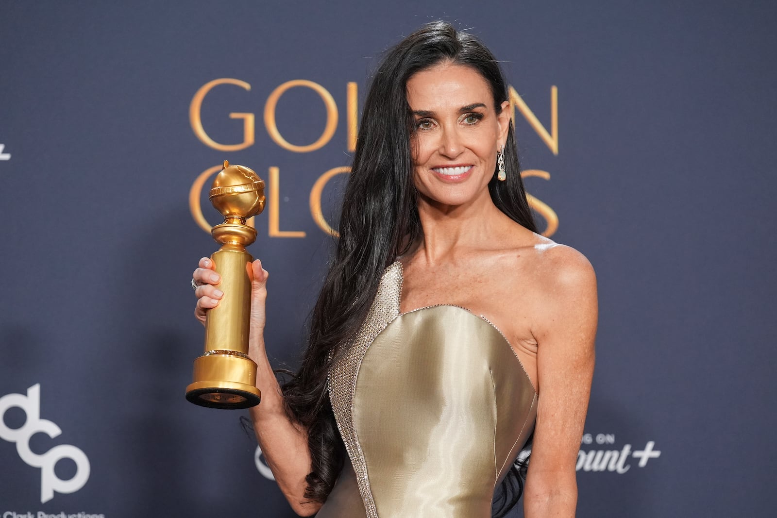 Demi Moore poses in the press room with the award for best performance by a female actor in a motion picture - musical or comedy for "The Substance" during the 82nd Golden Globes on Sunday, Jan. 5, 2025, at the Beverly Hilton in Beverly Hills, Calif. (AP Photo/Chris Pizzello)