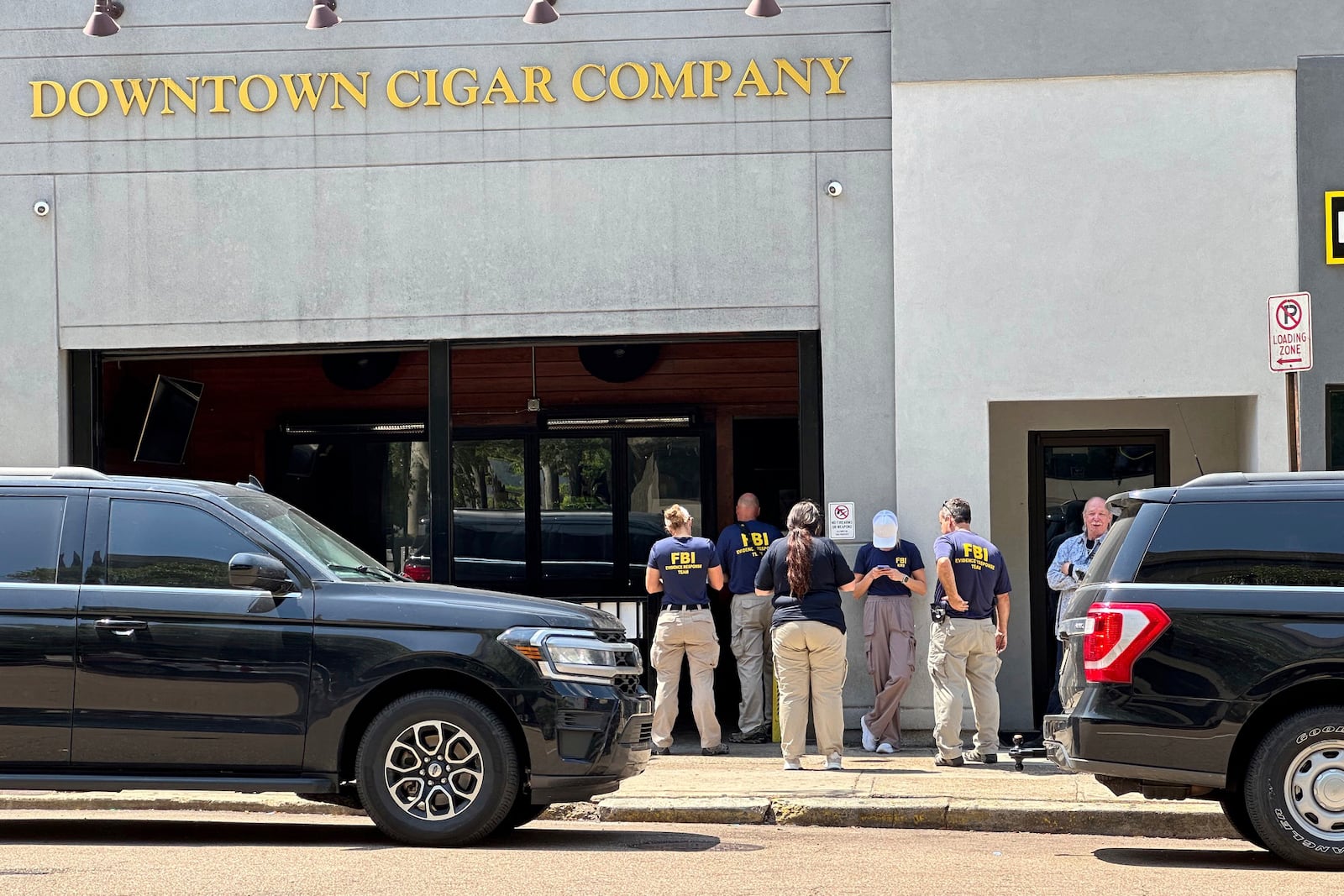 FILE - Federal authorities gather outside a business owned by Hinds County District Attorney Jody Owens, in downtown Jackson, Miss., Wednesday, May 22, 2024. (AP Photo/Rogelio V. Solis, File)