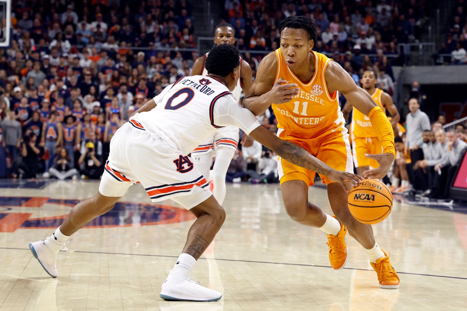 Auburn guard Tahaad Pettiford (0) steals the ball away from Tennessee guard Jordan Gainey (11) during the first half of an NCAA college basketball game, Saturday, Jan. 25, 2025, in Auburn. (AP Photo/Butch Dill)