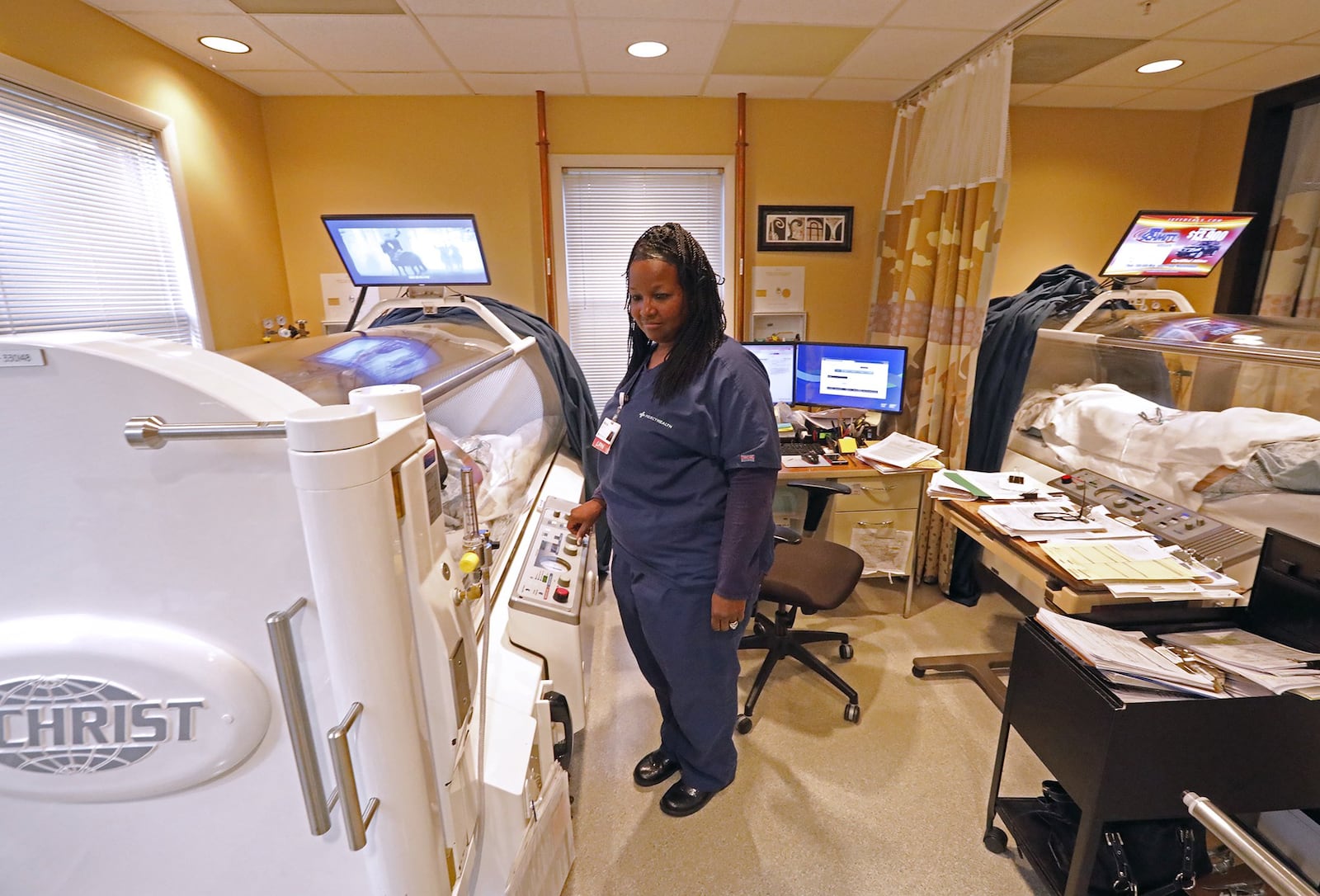 Marcie Hall, an LPN and Hyperbaric Technician, works with a patient in Hyperbaric Oxygen Therapy Tuesday at the Springfield Regional Wound Care Center. Bill Lackey.Staff