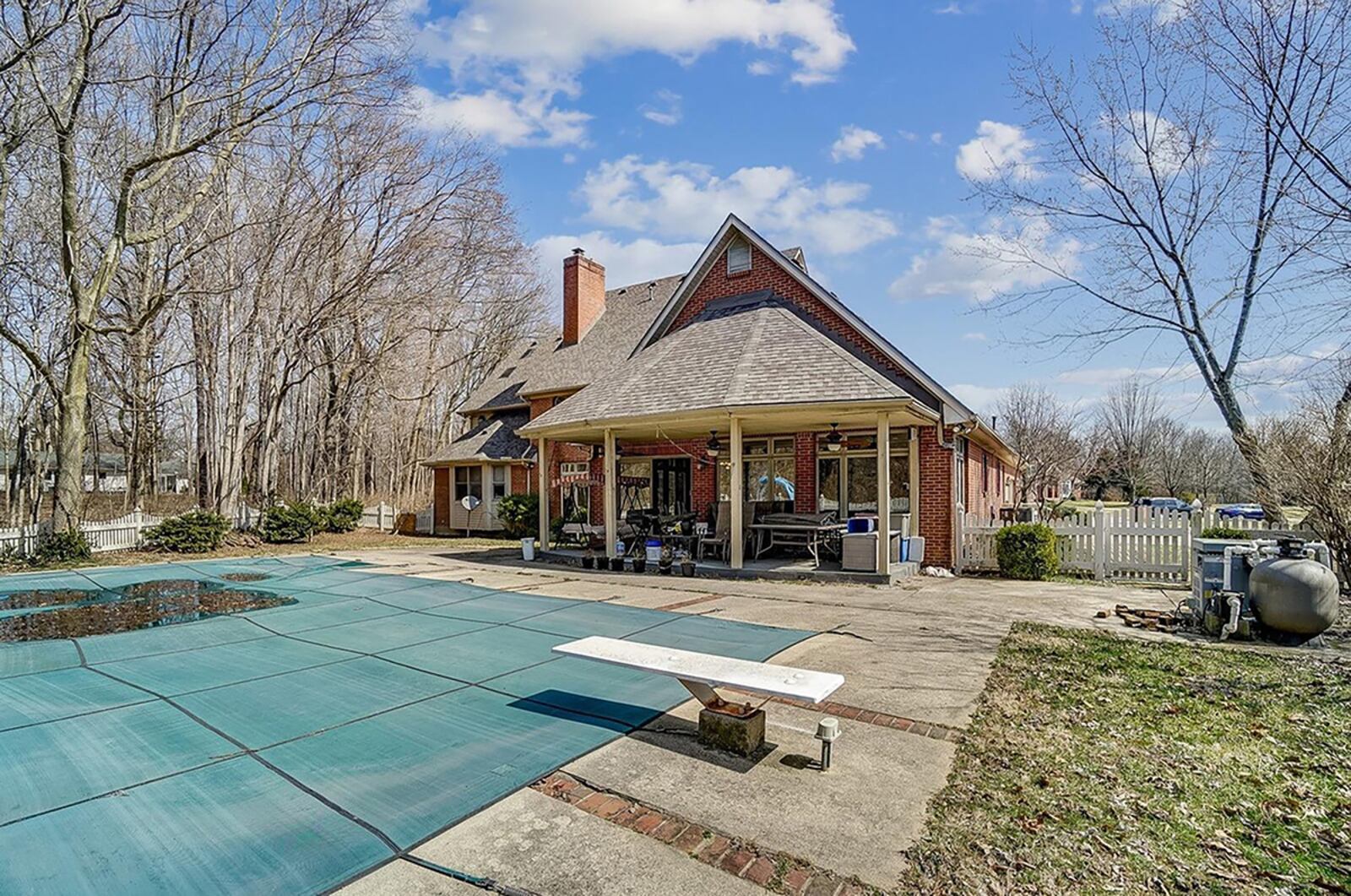 The rear yard has a saltwater, in-ground pool with slide and diving board, a covered patio with 3 ceiling fans and a picket fence. CONTRIBUTED PHOTO