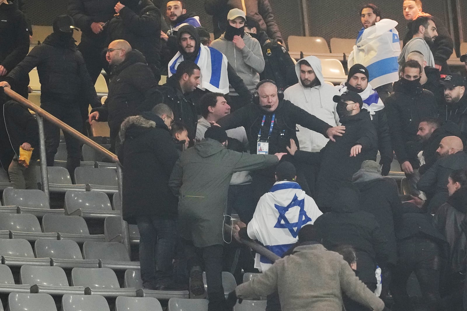 Fans argue on stands during the UEFA Nations League soccer match between France and Israel at the Stade de France stadium in Saint-Denis, outside Paris, Thursday Nov. 14, 2024. (AP Photo/Thibault Camus)