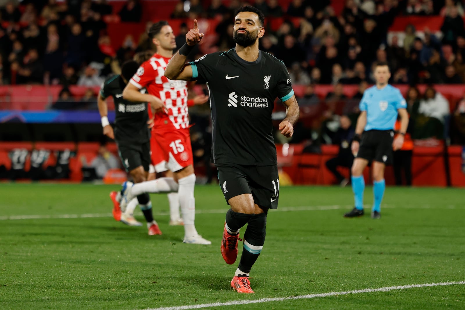 Liverpool's Mohamed Salah celebrates after scoring the opening goal during the Champions League soccer match between Girona and Liverpool at the Estadi Montilivi in Girona, Spain, Tuesday, Dec. 10, 2024. (AP Photo/Joan Monfort)