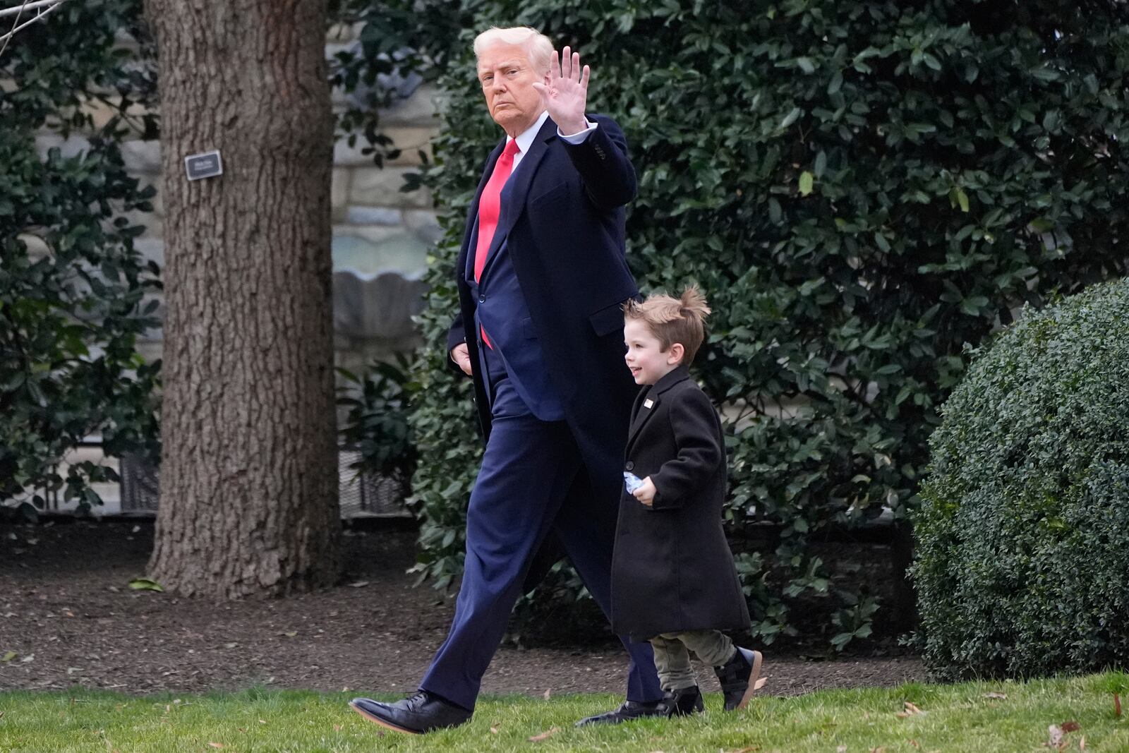 President Donald Trump walks with Elon Musk's son X Æ A-Xii on the South Lawn of the White House, Friday, March 14, 2025, in Washington before they depart on Marine One. (AP Photo/Alex Brandon)