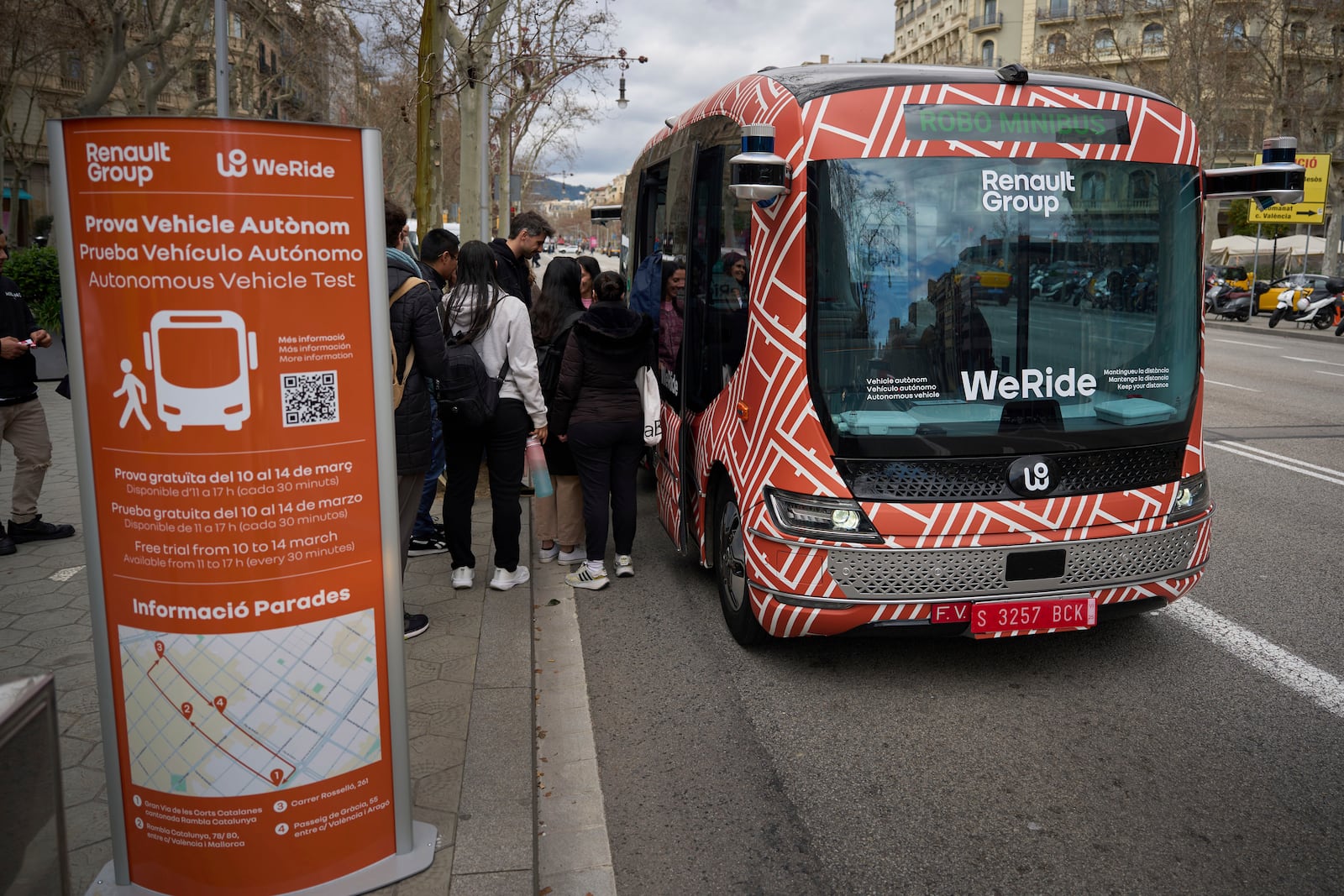 Passengers board a driverless mini-bus, presented by WeRide and Renault Group, in Barcelona downtown, Wednesday, March 12, 2025. (AP Photo/Emilio Morenatti)