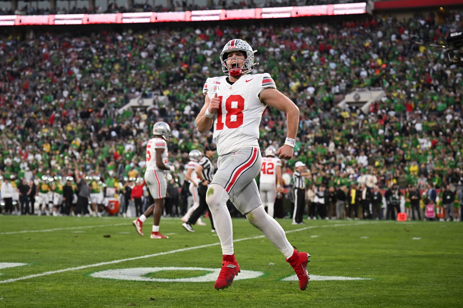 Ohio State quarterback Will Howard (18) reacts after a touchdown against Oregon during the second half in the quarterfinals of the Rose Bowl College Football Playoff, Wednesday, Jan. 1, 2025, in Pasadena, Calif. (AP Photo/Kyusung Gong)