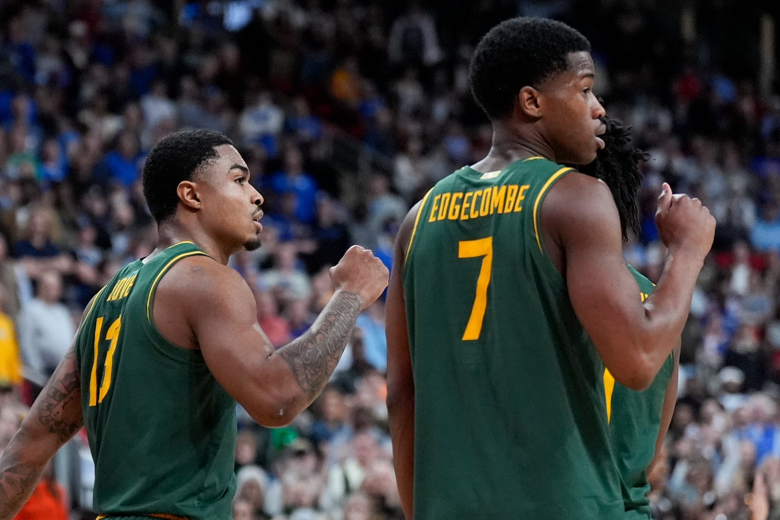 Baylor guard Langston Love, left, and guard VJ Edgecombe celebrates after scoring against Mississippi State during the second half in the first round of the NCAA college basketball tournament, Friday, March 21, 2025, in Raleigh, N.C. (AP Photo/Chris Carlson)