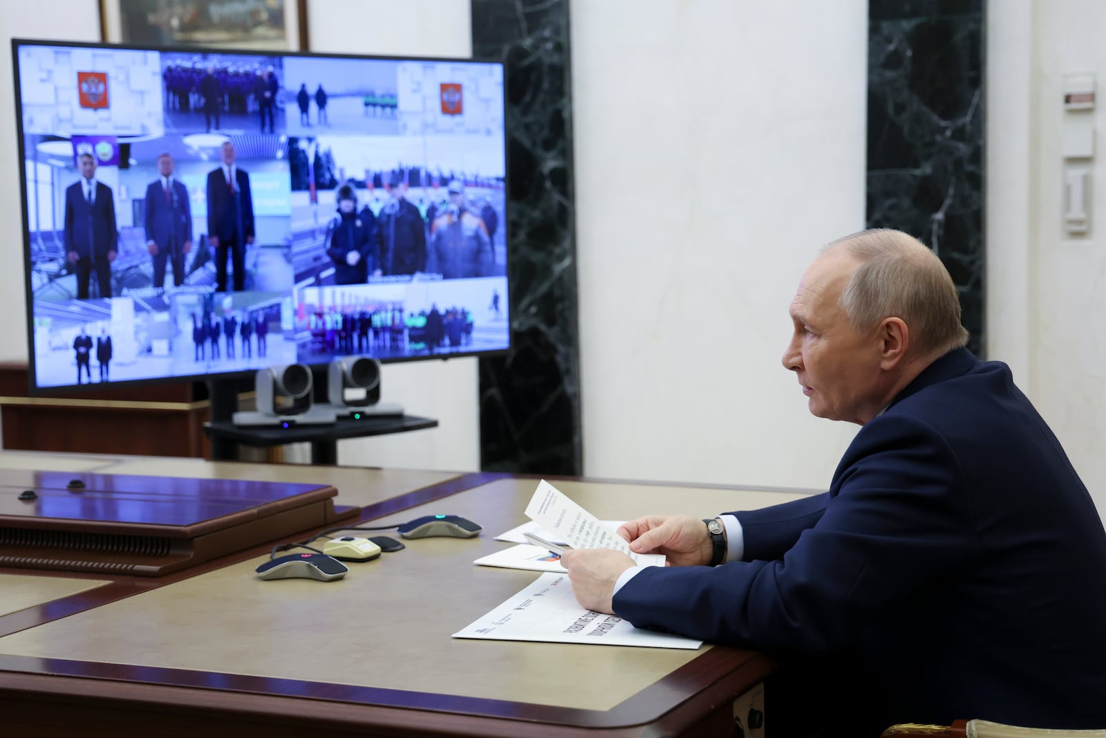 Russian President Vladimir Putin speaks as he attends a ceremony to launch new air and road infrastructure facilities in various country's regions via videoconference at the Kremlin in Moscow, Russia, Sunday, Dec. 22, 2024. (Alexander Kazakov, Sputnik, Kremlin Pool Photo via AP)