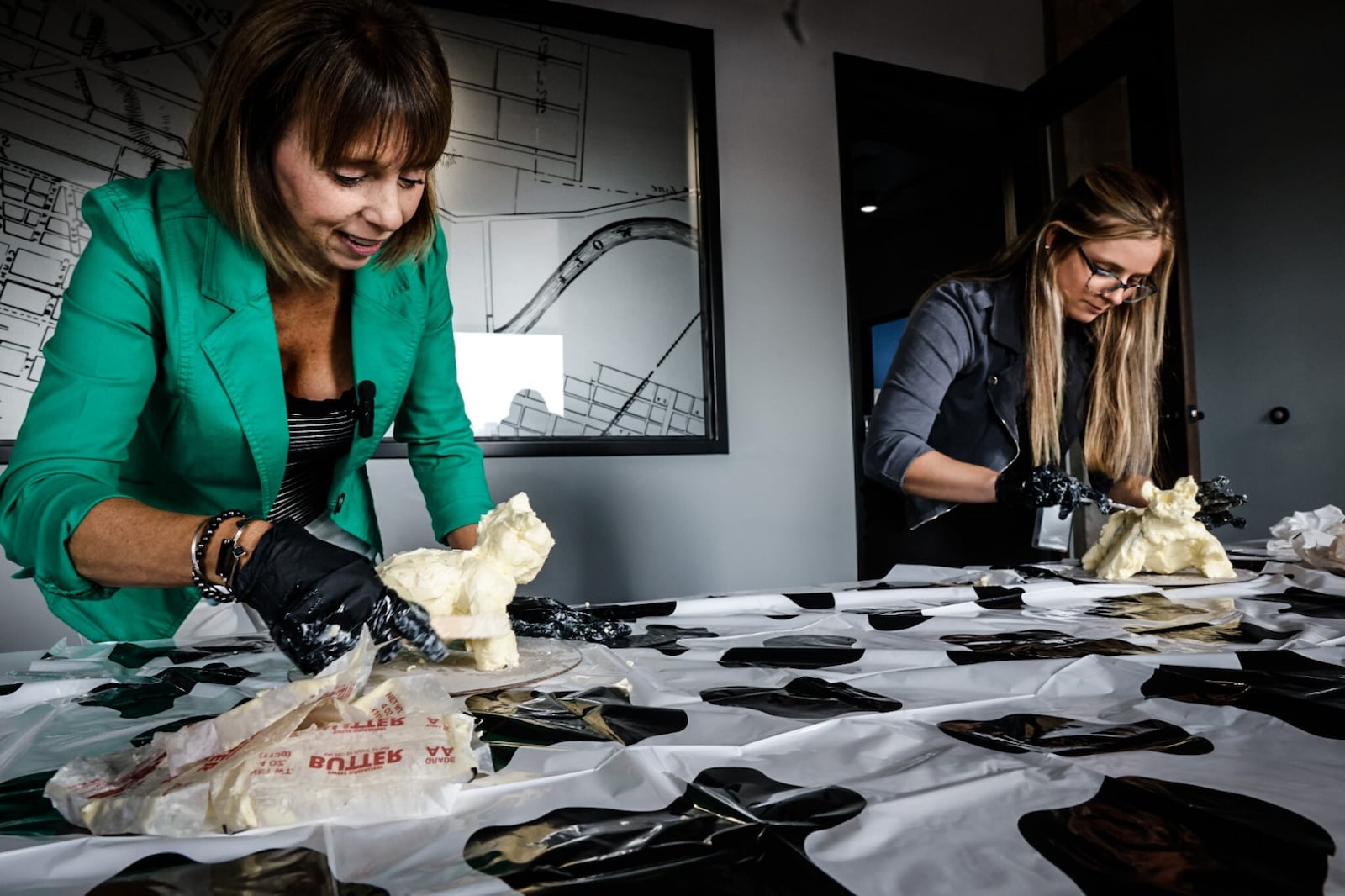 Food & Dining Reporter Natalie Jones (right) and Publisher Suzanne Klopfenstein (left) attempted to make their own butter cow in honor of the display at the Ohio State Fair. JIM NOELKER/STAFF