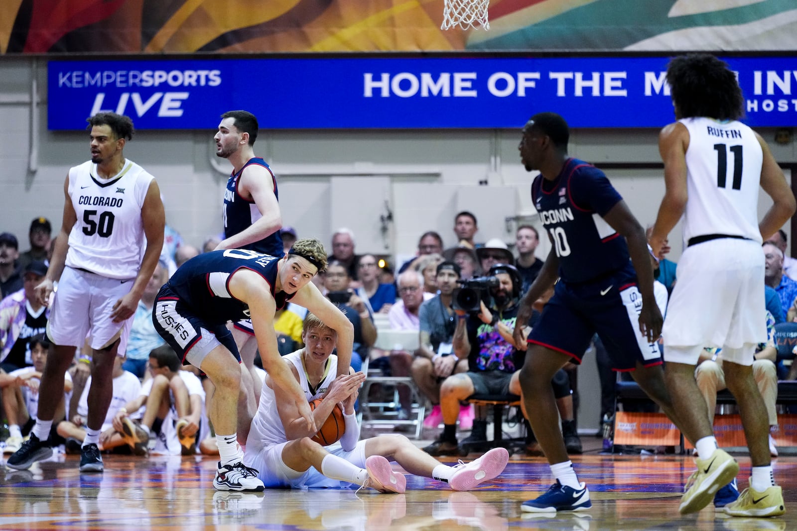 Colorado forward Trevor Baskin calls for a timeout as UConn forward Liam McNeeley stands over him while trying to grab the ball during the second half of an NCAA college basketball game at the Maui Invitational Tuesday, Nov. 26, 2024, in Lahaina, Hawaii. Colorado won 73-72. (AP Photo/Lindsey Wasson)