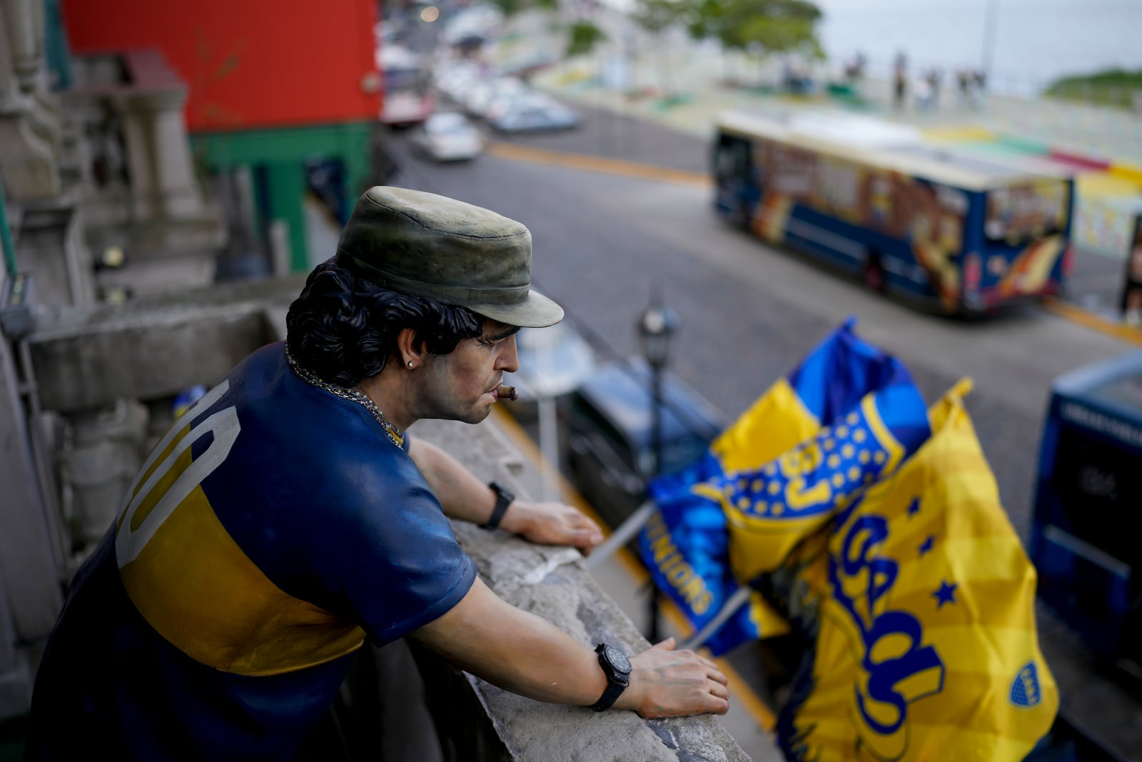 A statue of late soccer star Diego Maradona looks out from a balcony at "Lo del Diego" bar in La Boca, Buenos Aires, Argentina, Sunday, March 9, 2025. (AP Photo/Natacha Pisarenko)