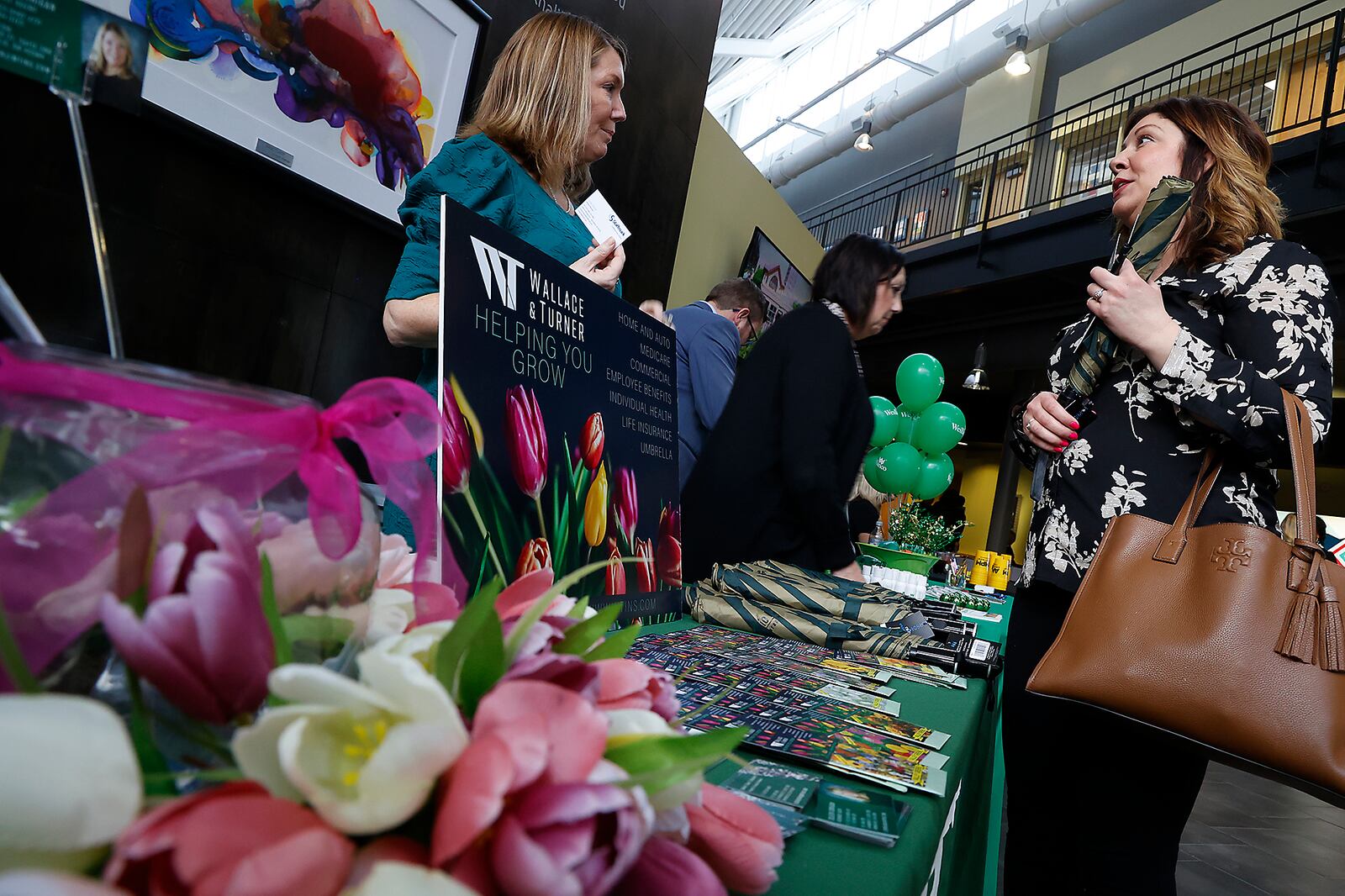 Colleen Corrigan, from Wallace & Turner Insurance, talks with Leslie Leibold during the Greater Springfield Partnership's annual expo and awards dinner Thursday, Feb. 23, 2023 at the Hollenbeck Bayley Creative Arts Center and Conference Center. The annual event brings together dozens of Springfield and Clark County businesses and organizations. BILL LACKEY/STAFF