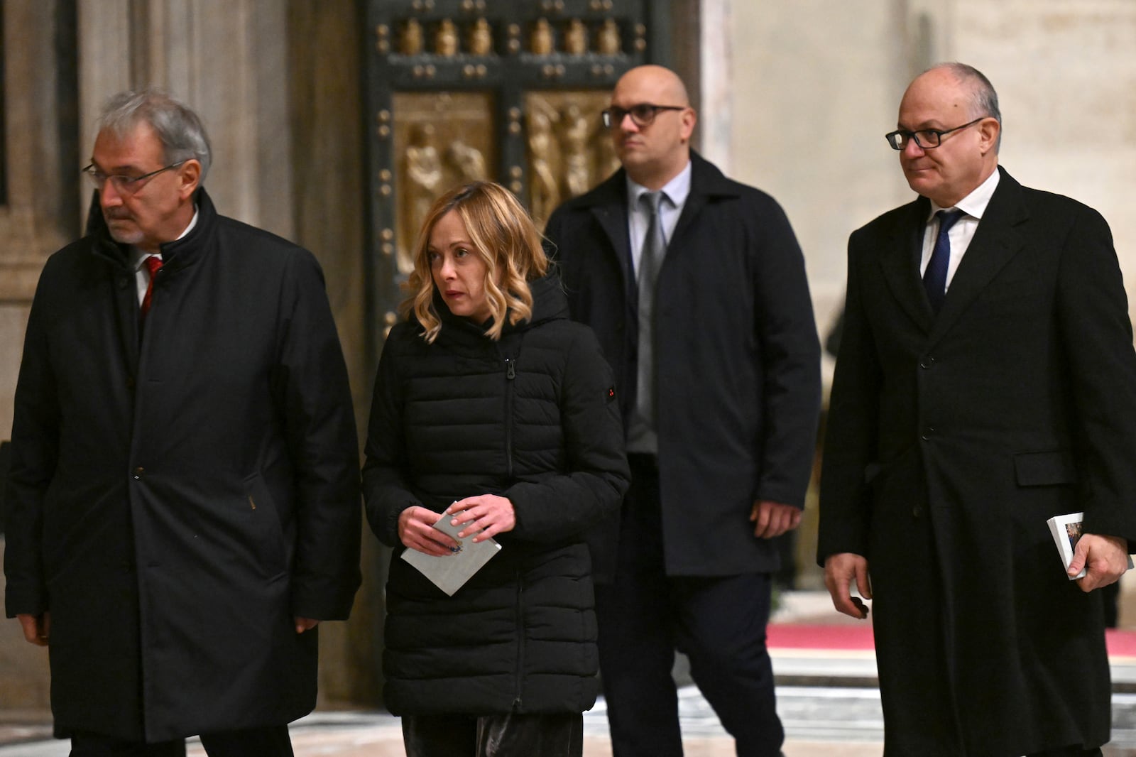 Italy's Prime Minister Giorgia Meloni, center left, and Rome's Mayor Roberto Gualtieri, right, pass through after Pope Francis opened the Holy Door to mark the opening of the 2025 Catholic Holy Year, or Jubilee, in St. Peter's Basilica, at the Vatican, Tuesday Dec. 24, 2024. (Alberto Pizzoli/Pool via AP)