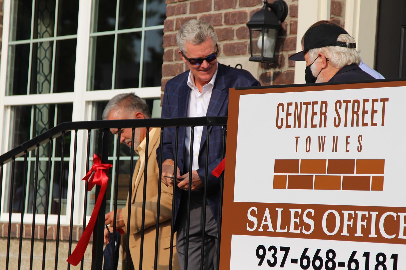 Charlie Simms, the president of Charles Simms Development, participates in a ribbon cutting ceremony Wednesday for a model home that is part of the Center Street Townes project in downtown Springfield.