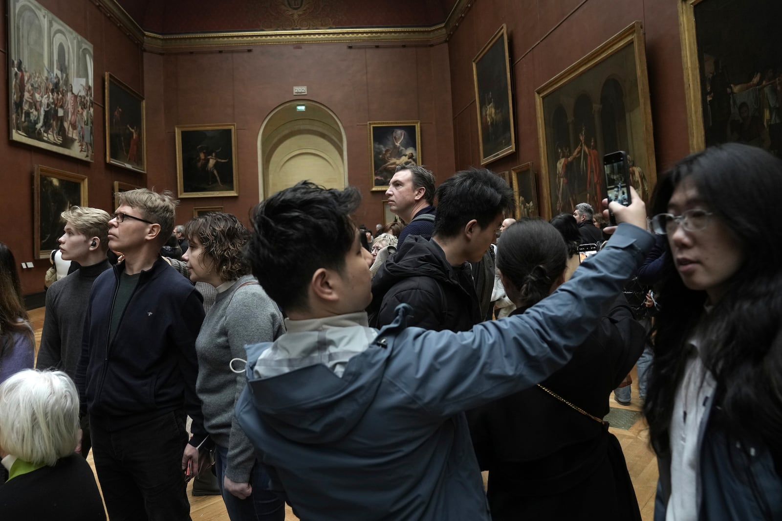 People visit Le Louvre museum, Monday, Jan. 27, 2025 in Paris. (AP Photo/Thibault Camus)