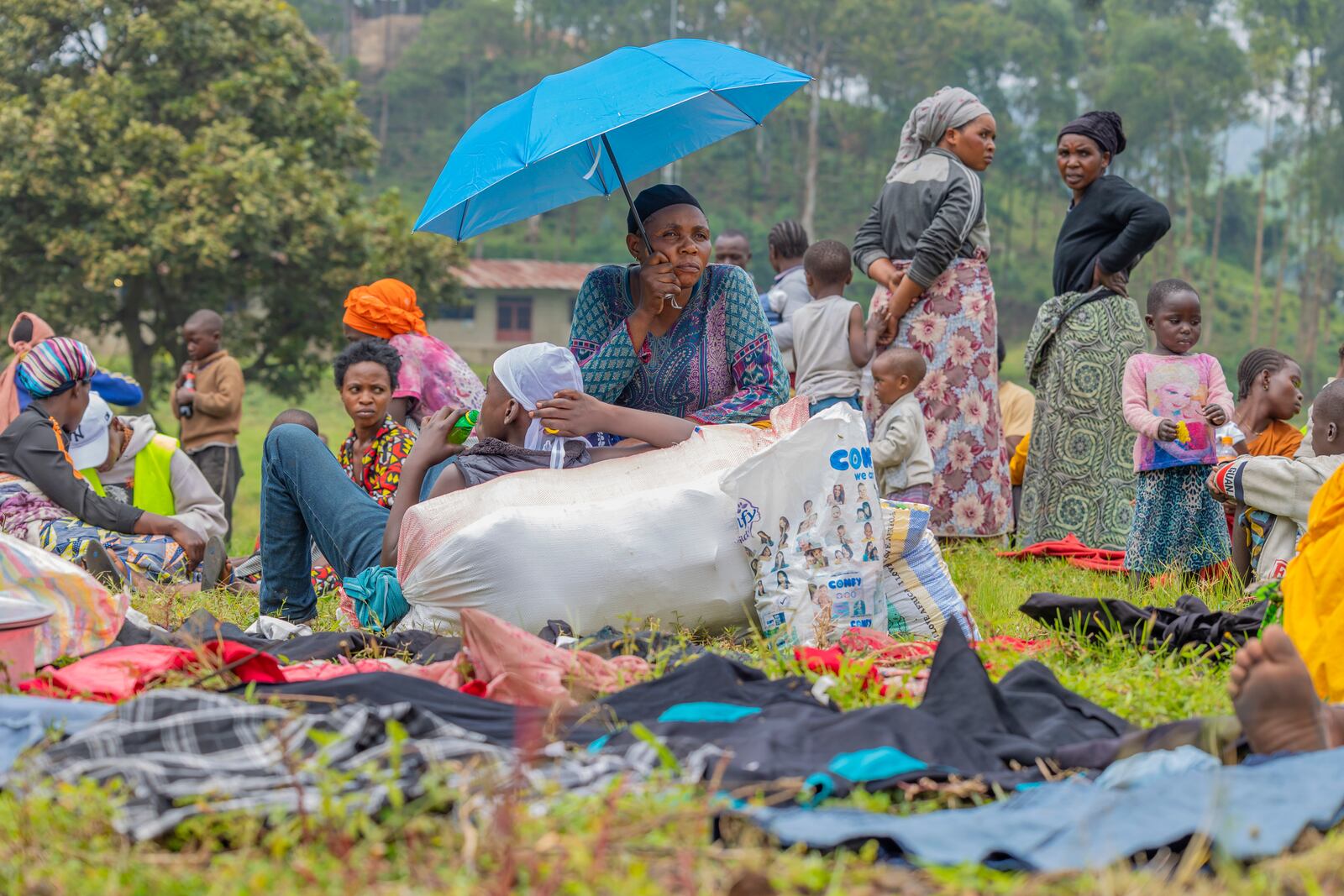 People who crossed from Congo wait for assistance in Gyseny, Rwanda, Tuesday, Jan. 28, 2025, following M23 rebels' advances into eastern Congo's capital Goma. (AP Photo/Yuhi Irakiza)