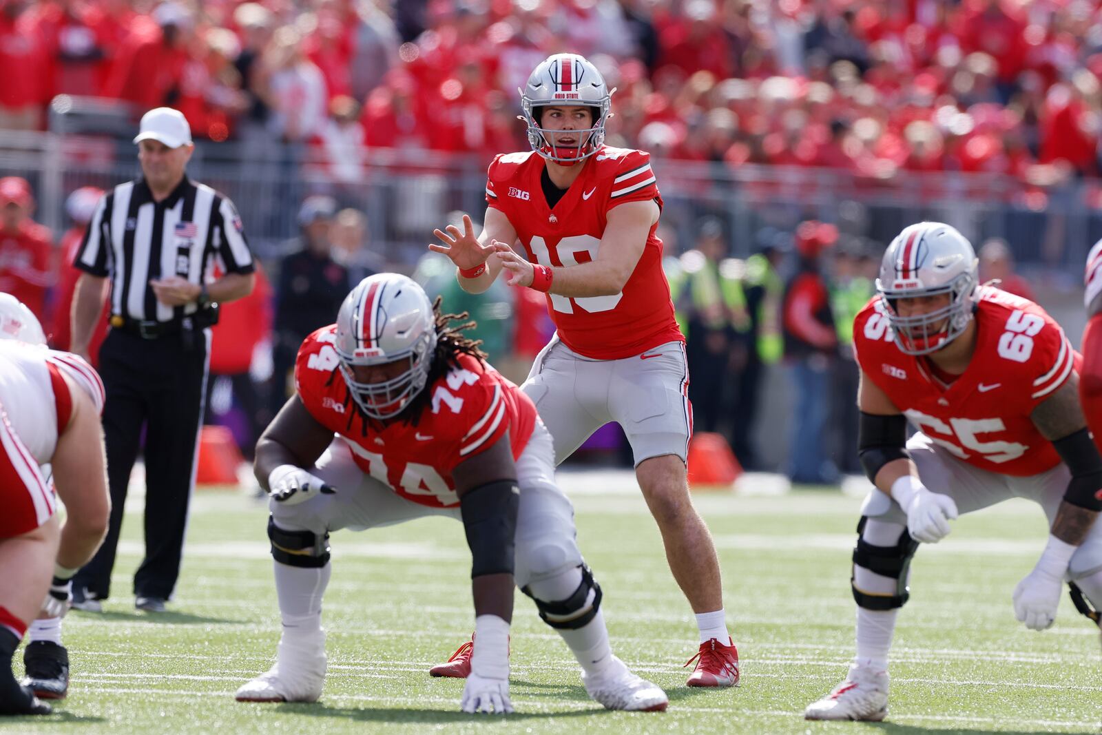 FILE - Ohio State quarterback Will Howard prepares to handle the snap during an NCAA college football game against Nebraska, Saturday, Oct. 26, 2024, in Columbus, Ohio. (AP Photo/Jay LaPrete, File)