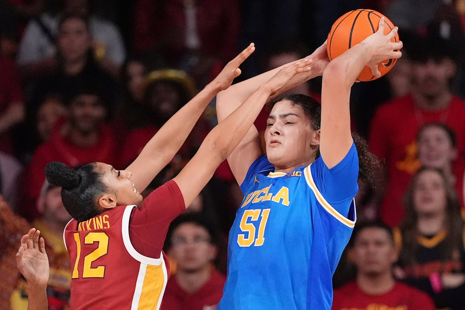 UCLA center Lauren Betts, right, tries to pass while under pressure from Southern California guard JuJu Watkins during the second half of an NCAA college basketball game, Thursday, Feb. 13, 2025, in Los Angeles. (AP Photo/Mark J. Terrill)