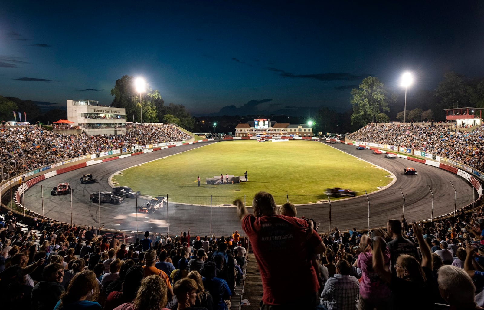 FILE - Race fans react as driver Burt Myers gets caught up between turns one and two during the 100-lap Modified race on Saturday, July 22, 2023, at Bowman Gray Stadium in Winston-Salem, N.C. (Walt Unks/The Winston-Salem Journal via AP, File)