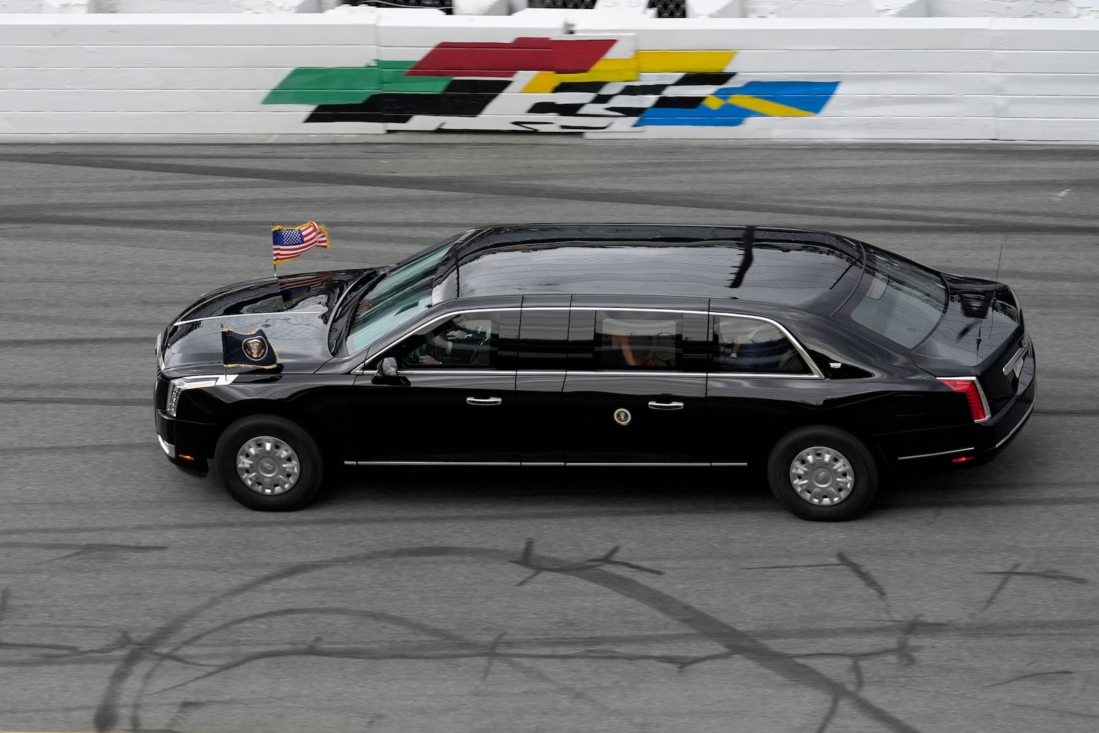 President Donald Trump rides in the presidential limousine known as "The Beast" as he takes a pace lap ahead of the start of the NASCAR Daytona 500 auto race at Daytona International Speedway, Sunday, Feb. 16, 2025, in Daytona Beach, Fla. (AP Photo/Chris O'Meara)