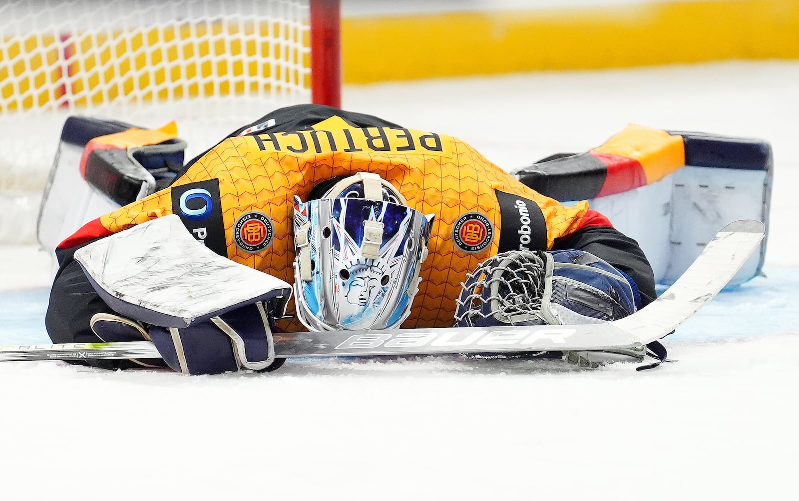 Germany goaltender Nico Pertuch lies on the ice during the third period after allowing the United States' eighth goal during IIHF World Junior Hockey Championship preliminary round game action in Ottawa, Ontario, Thursday, Dec. 26, 2024. (Sean Kilpatrick/The Canadian Press via AP)