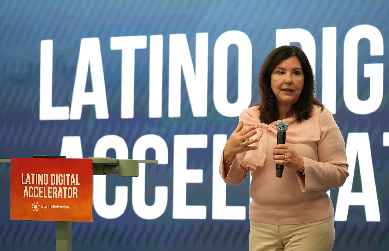 Vicky Lazo, a teacher with Southwest Miami Senior High School, speaks during a Hispanic Federation event in Miami, Tuesday, Jan. 28, 2025, where the organization announced a new investment from a company, to help Latinos learn digital skills. (AP Photo/Lynne Sladky)