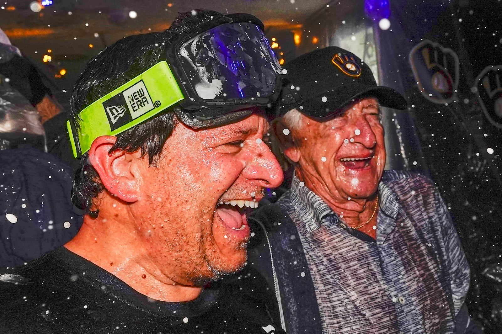 FILE - Milwaukee Brewers' owner Mark Attanasio and broadcaster Bob Uecker celebrate after clinching the National League Central Division after a baseball game against the St. Louis Cardinals Tuesday, Sept. 26, 2023, in Milwaukee. (AP Photo/Morry Gash)