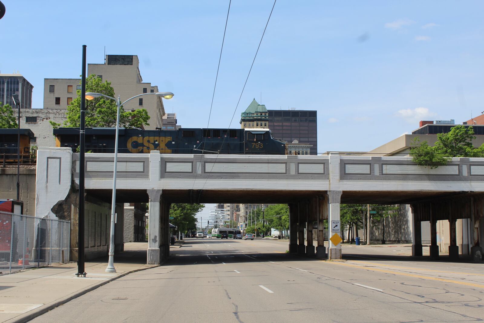 A CSX train passes over South Main Street in downtown Dayton on Thursday. CORNELIUS FROLIK / STAFF