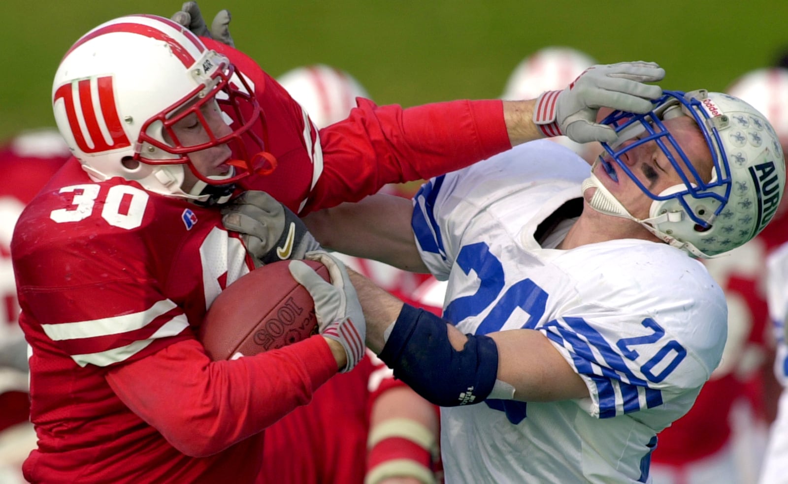 Wittenberg's Casey Donaldson (30) fights off Aurora defender Anton Hruby (20) as he carries the ball into the end zone for a Wittenberg touchdown during their Division III playoff game in 2000.